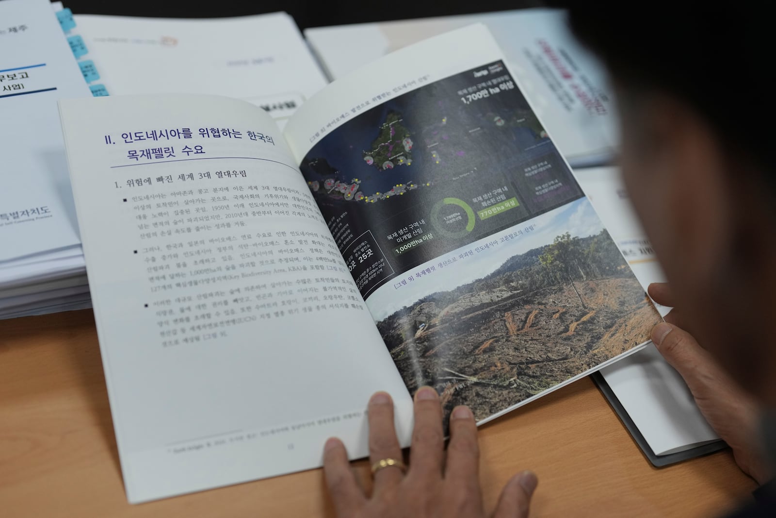 South Korean National Assembly member Moon Dae-Lim, looks at a policy report on the state audit authored by him at his office of the National Assembly in Seoul, South Korea, Wednesday, Nov. 27, 2024. (AP Photo/Lee Jin-man)