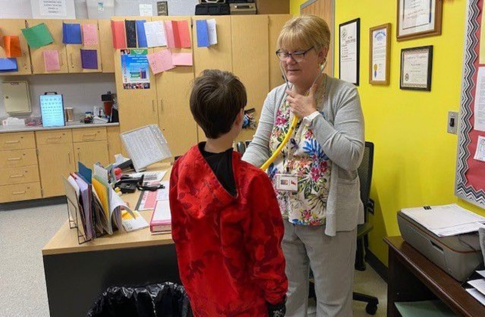 Fairfield Schools Lead Nurse Pam Buehler, seen here tending to a sick student, is among the many local school nurses now being lauded for their hard work during the initial school year - 2020 and beyond - after the onset of the COVID-19 pandemic. State and local school officials say the nurses were heroes in keeping thousands of students and school staffers safe during the deadlier days of the now fading pandemic. CONTRIBUTED