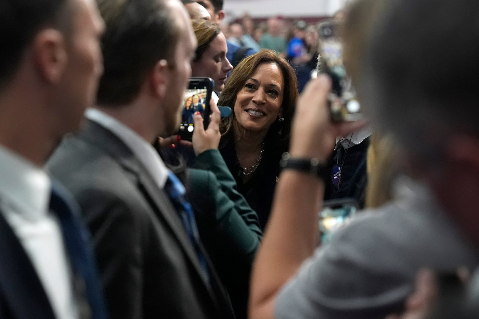 Democratic presidential nominee Vice President Kamala Harris, center, takes a photo with a supporter after speaking at a campaign rally at the University of Wisconsin La Crosse, in La Crosse, Wis., Thursday, Oct. 17, 2024. (AP Photo/Jacquelyn Martin)