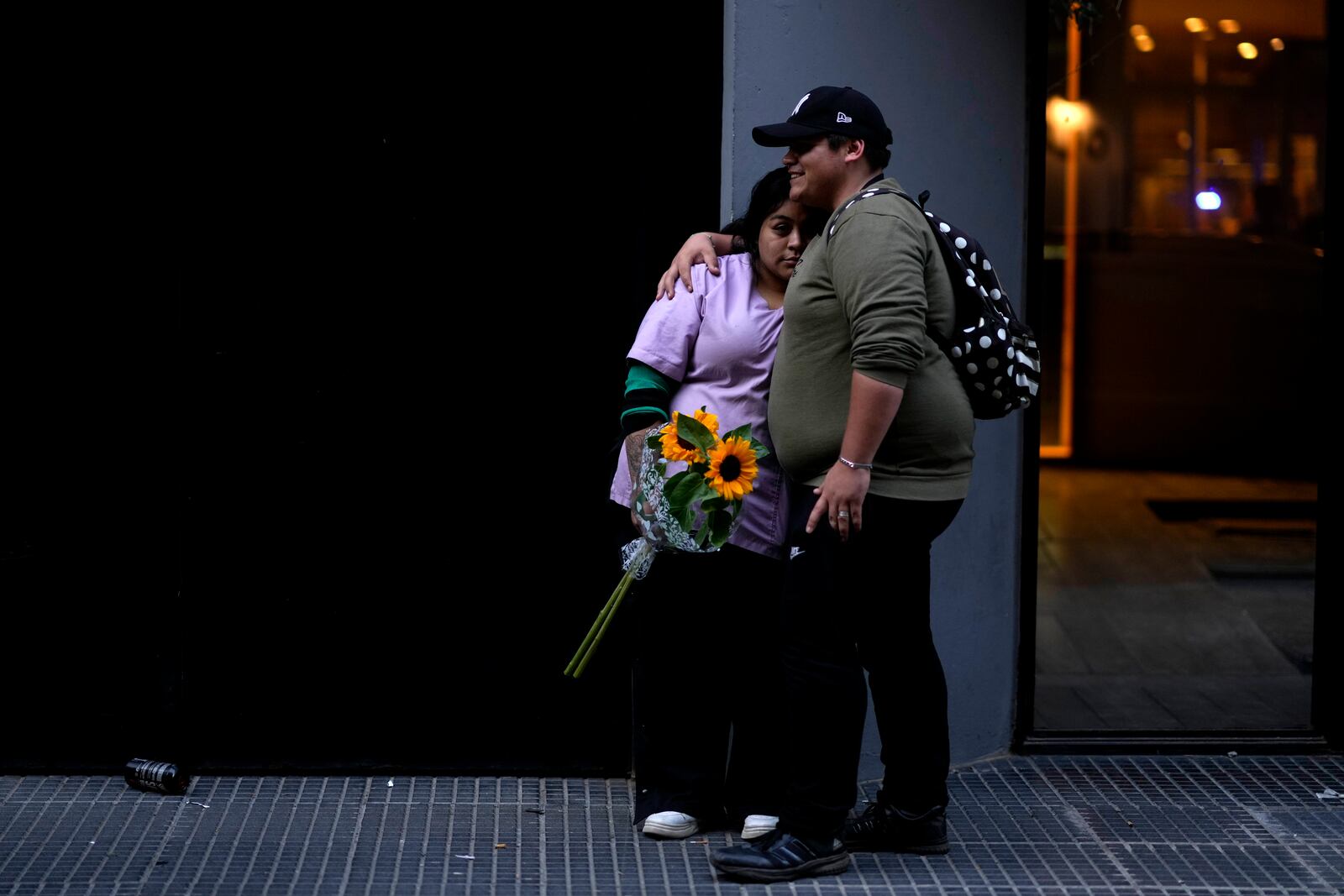 Fans of former One Direction singer Liam Payne stand outside the hotel where he was found dead after falling from a balcony in Buenos Aires, Argentina, Thursday, Oct. 17, 2024. (AP Photo/Natacha Pisarenko)