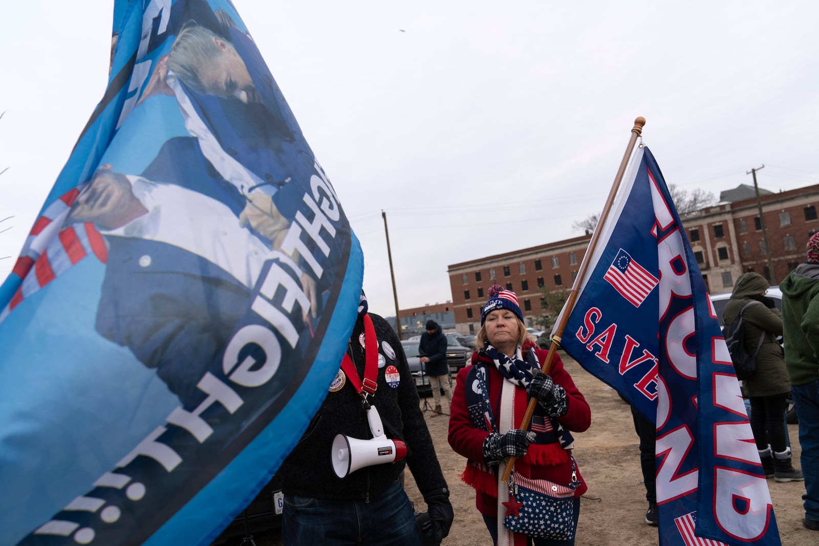 Supporters of President Donald stand with their flags in support of people convicted for their part in the Jan. 6 riot at the U.S. Capitol at the DC Central Detention Facility in Washington, Tuesday, Jan. 21, 2025. (AP Photo/Jose Luis Magana)