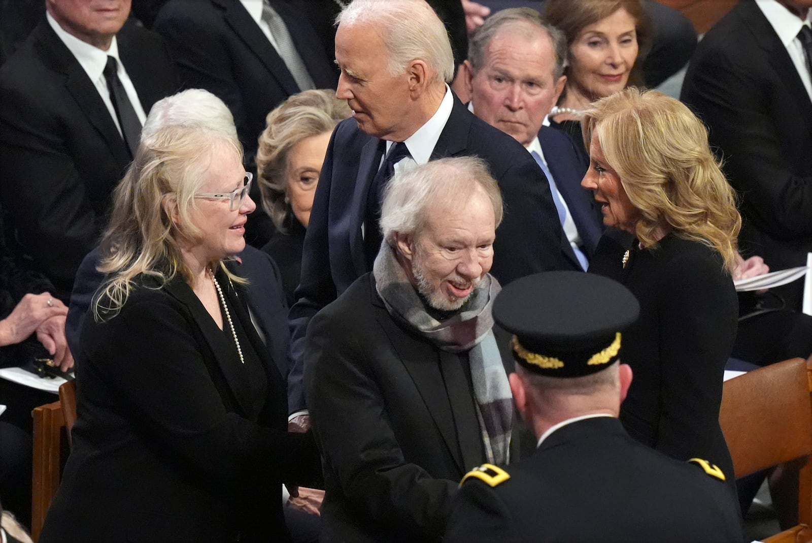 President Joe Biden and first lady Jill Biden greet Amy Carter and Jeff Carter before the state funeral for former President Jimmy Carter at Washington National Cathedral in Washington, Thursday, Jan. 9, 2025. (AP Photo/Jacquelyn Martin)