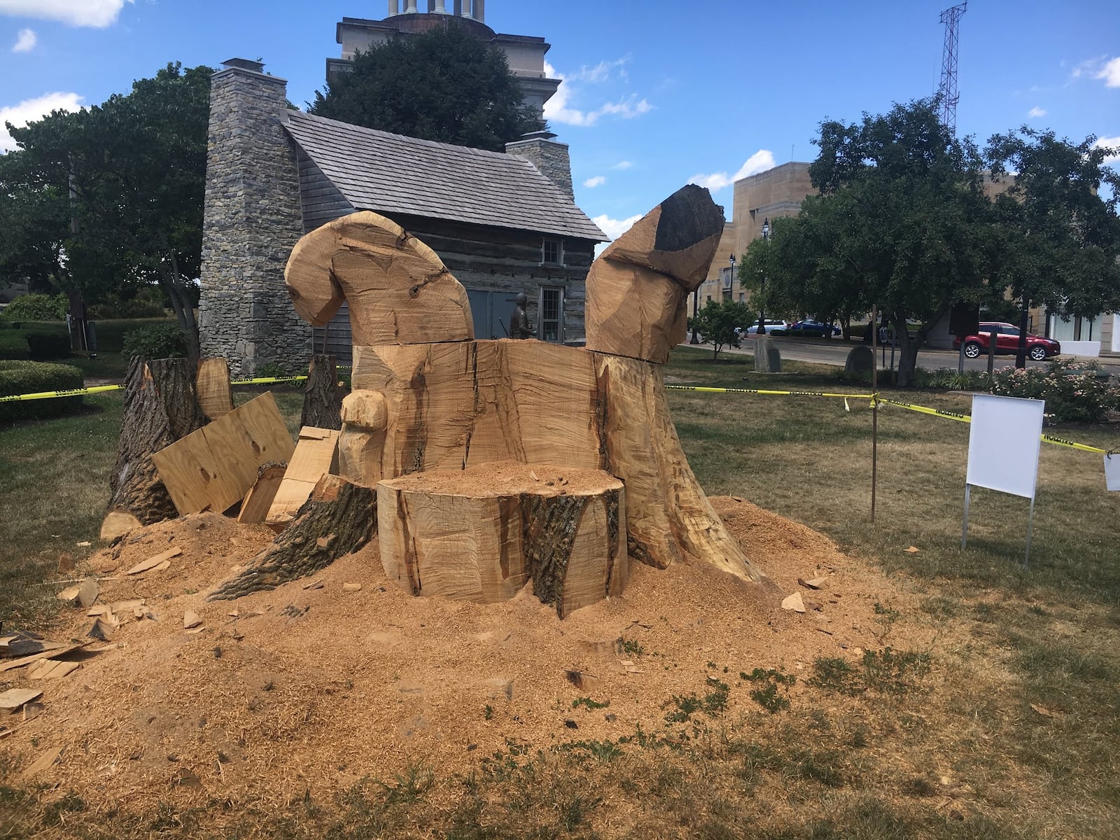 The base of an oak tree, which once stood between the Fitton Center and the Hamilton Monument on Monument Avenue, is being carved into a sculptural bench.