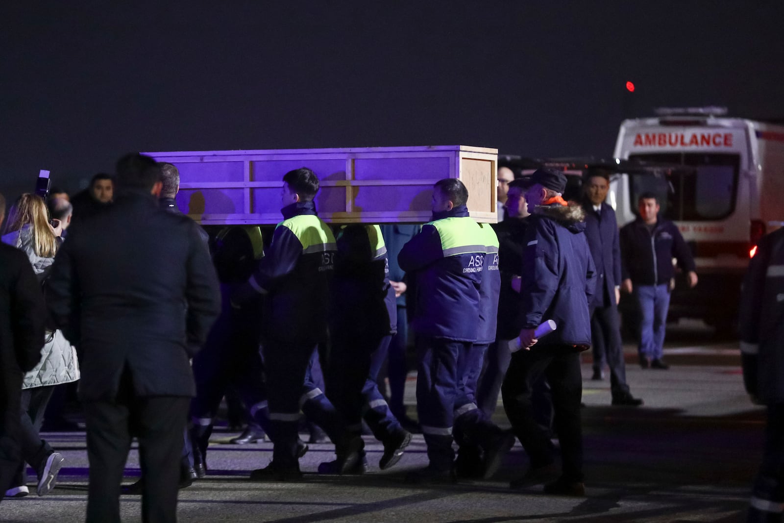 Workers carry a coffin with a body of a victim from a medical plane after the Azerbaijani Airline crashed, near the Kazakhstani city of Aktau, upon their arrival at the Heydar Aliyev International Airport outside Baku, Azerbaijan, Thursday, Dec. 26, 2024. (AP Photo)