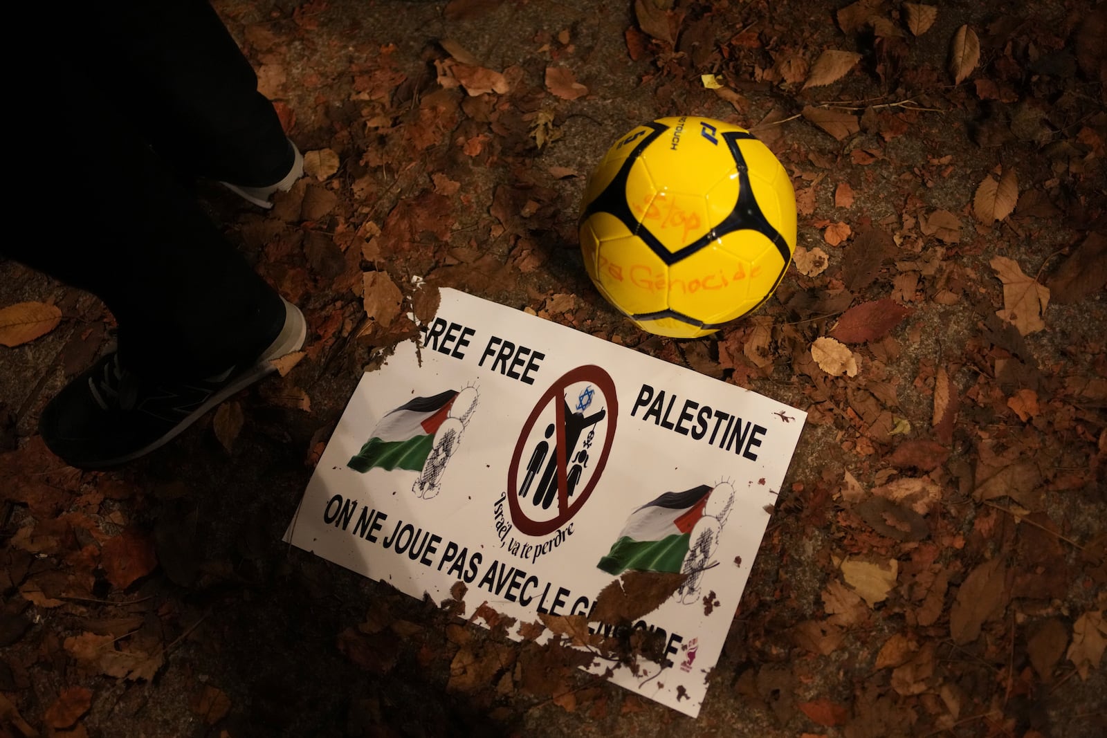 A soccer ball and a spotter are pictured during a rally in support of the Palestinian people, ahead of the Nations League soccer match France against Israel, Thursday, Nov. 14, 2024 in Saint-Denis, outside Paris. (AP Photo/Christophe Ena)