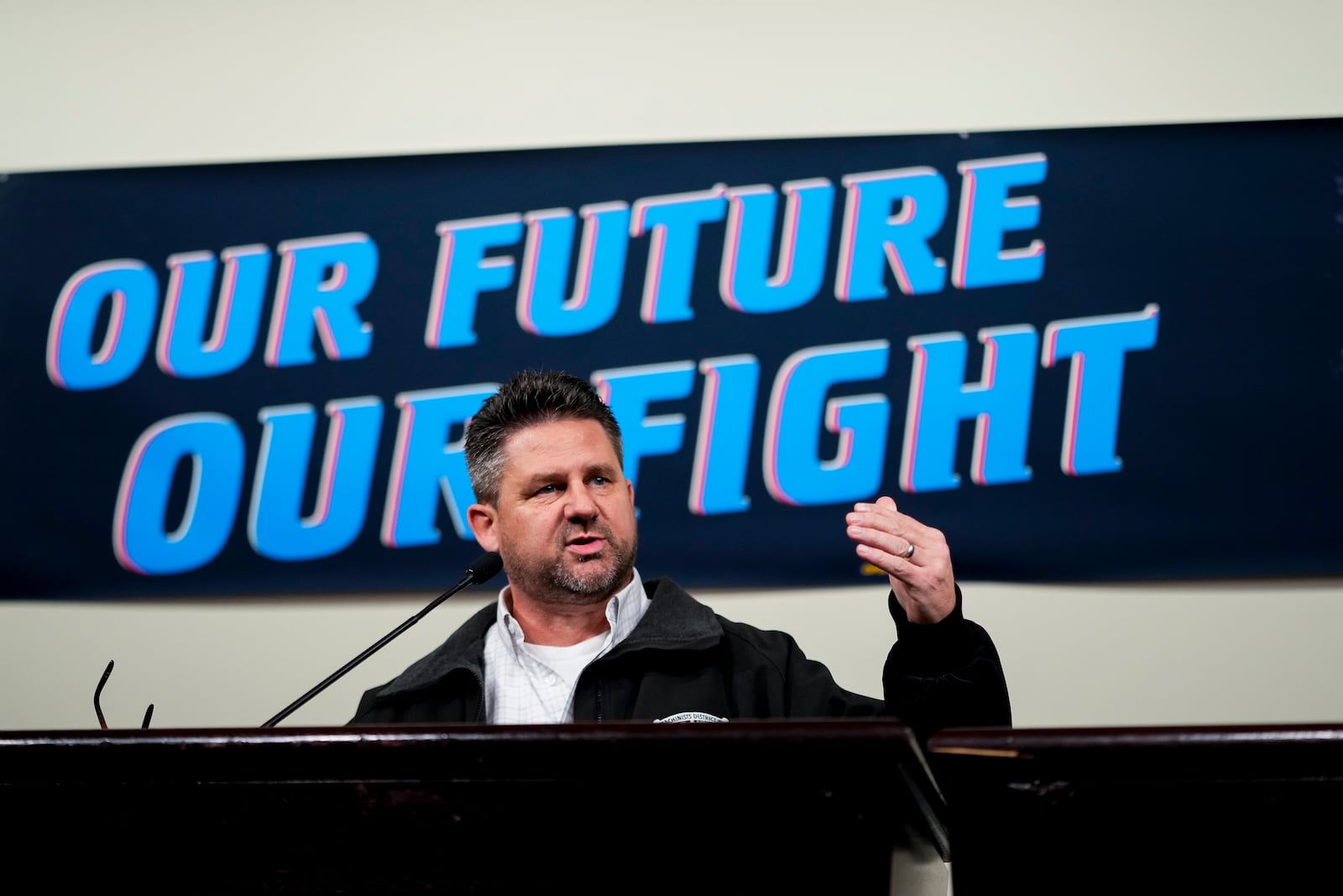 IAM District 751 president Jon Holden speaks to union members while announcing that they voted to reject a new contract offer from Boeing, Wednesday, Oct. 23, 2024, at Seattle Union Hall in Seattle. (AP Photo/Lindsey Wasson)