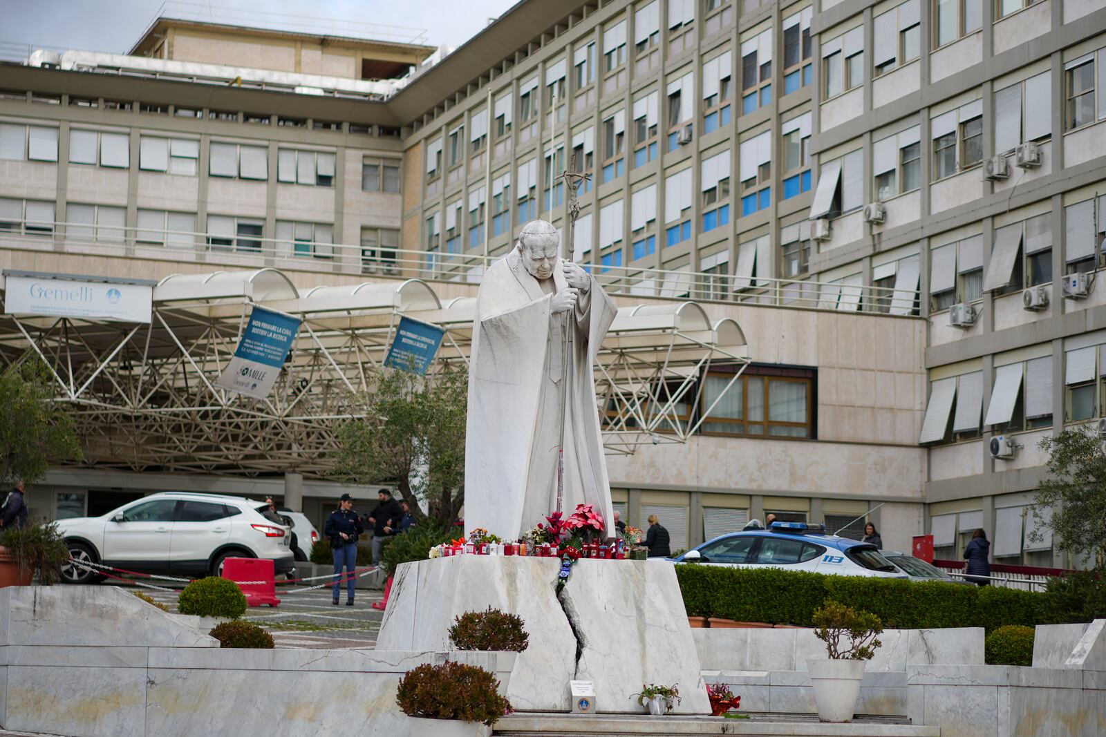 A statue of Pope John Paul II in front of the Agostino Gemelli Polyclinic in Rome, Friday, Feb. 14, 2025, where Pope Francis has been hospitalized to undergo diagnostic tests and to continue his ongoing treatment for bronchitis. (AP Photo/Andrew Medichini)