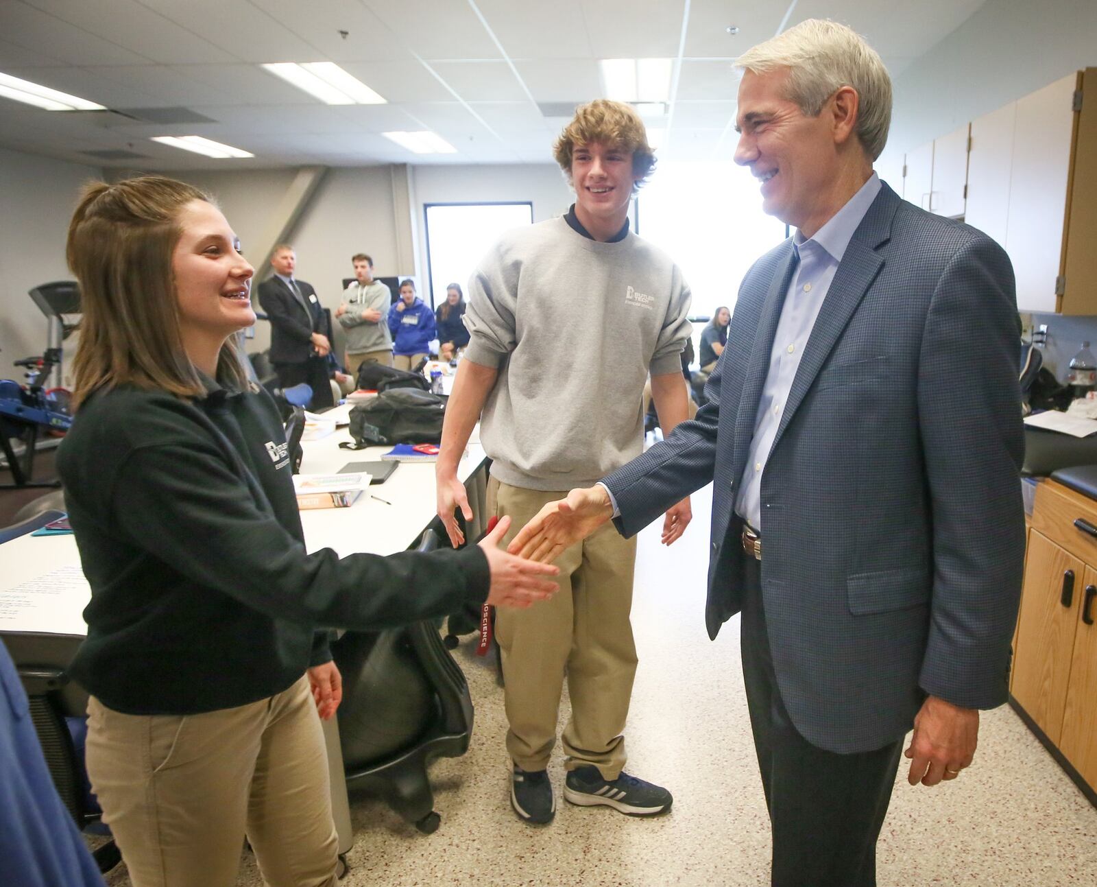 U.S. Sen. Rob Portman (R-Ohio) talks with Butler Tech Exercise Science students Kyle Kepner and Allison Wilmans during at tour of the Butler Tech Bioscience campus in West Chester Twp. on Dec. 20. GREG LYNCH / STAFF