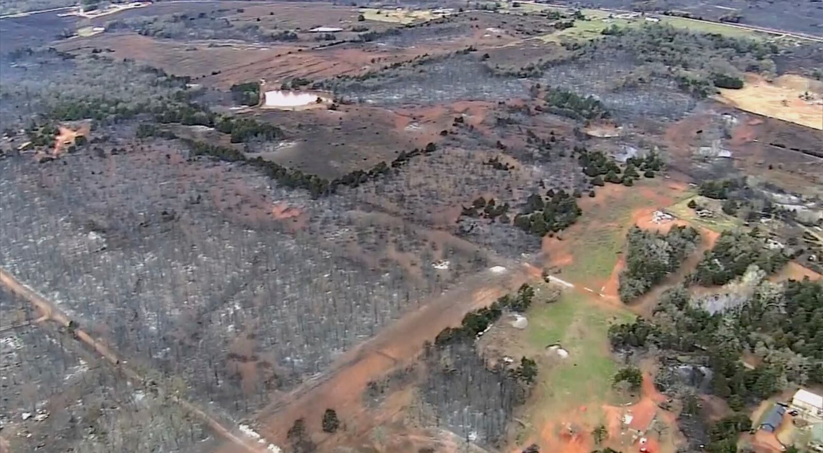 This image provided by shows aerials over the damage caused by the wildfires in Logan County, Okla. (KOCO via AP)