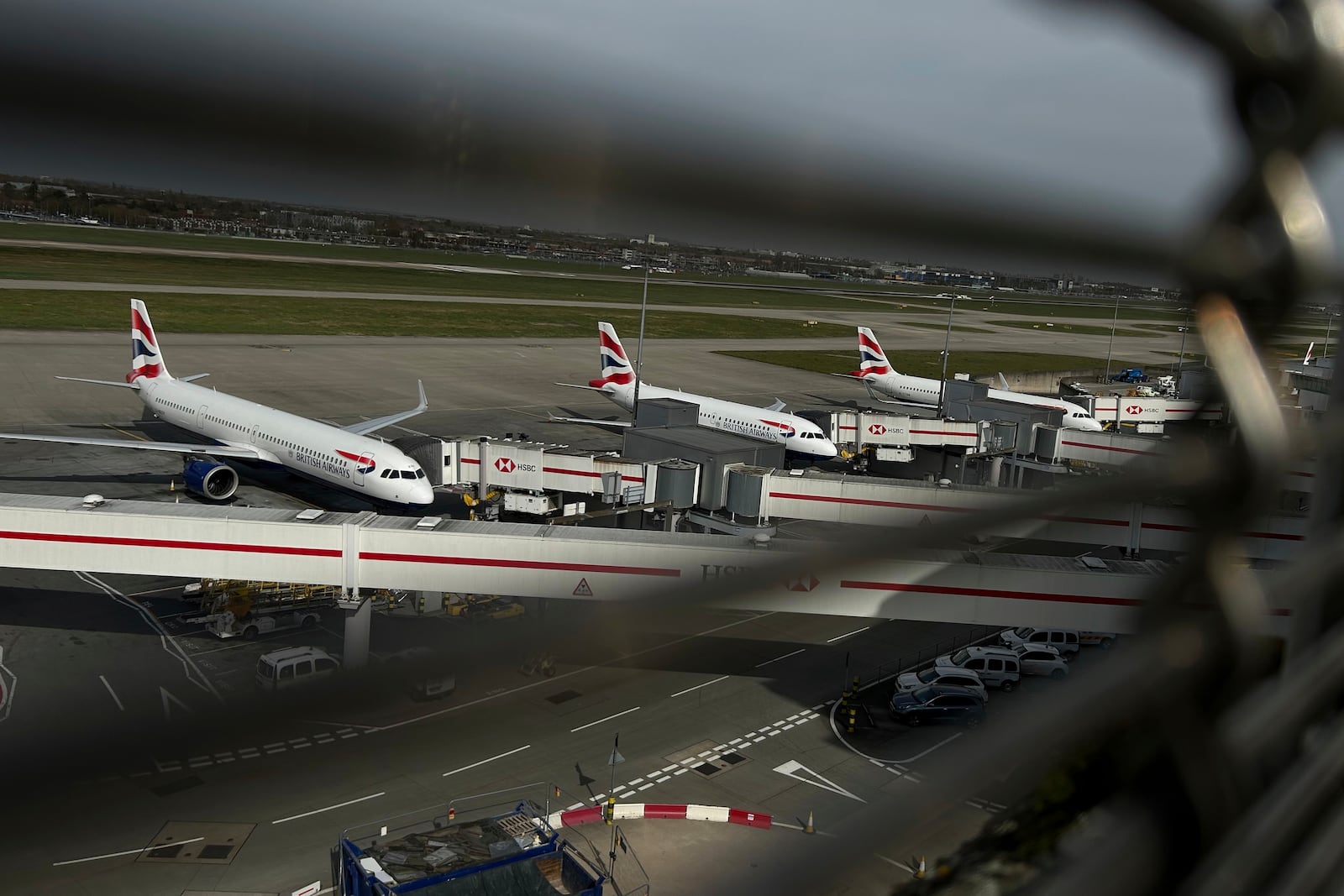 Planes are parked at Terminal 5 as Britain's Heathrow Airport has closed for the full day Friday after an electrical substation fire knocked out its power, disrupting flights for hundreds of thousands of passengers at one of Europe's biggest travel hubs in London, Friday, March 21, 2025.(AP Photo/Kin Cheung)