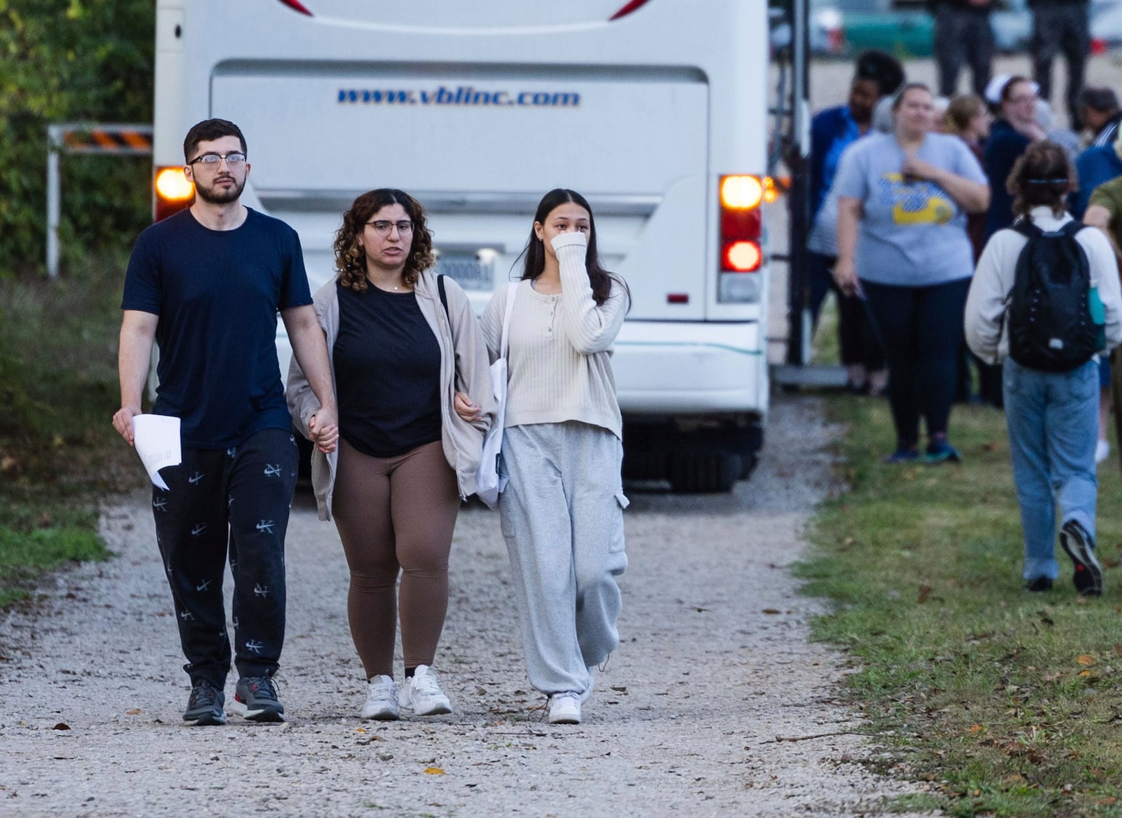 FILE - Summer Hishmeh, center, and Sakura Hassan, both from St. Louis, hold hands and cry as they walk with another man away from a protest against the execution of Marcellus Williams outside of the Missouri Department of Corrections prison, Tuesday, Sept. 24, 2024, in Bonne Terre, Mo. (Zachary Linhares/St. Louis Post-Dispatch via AP, File)