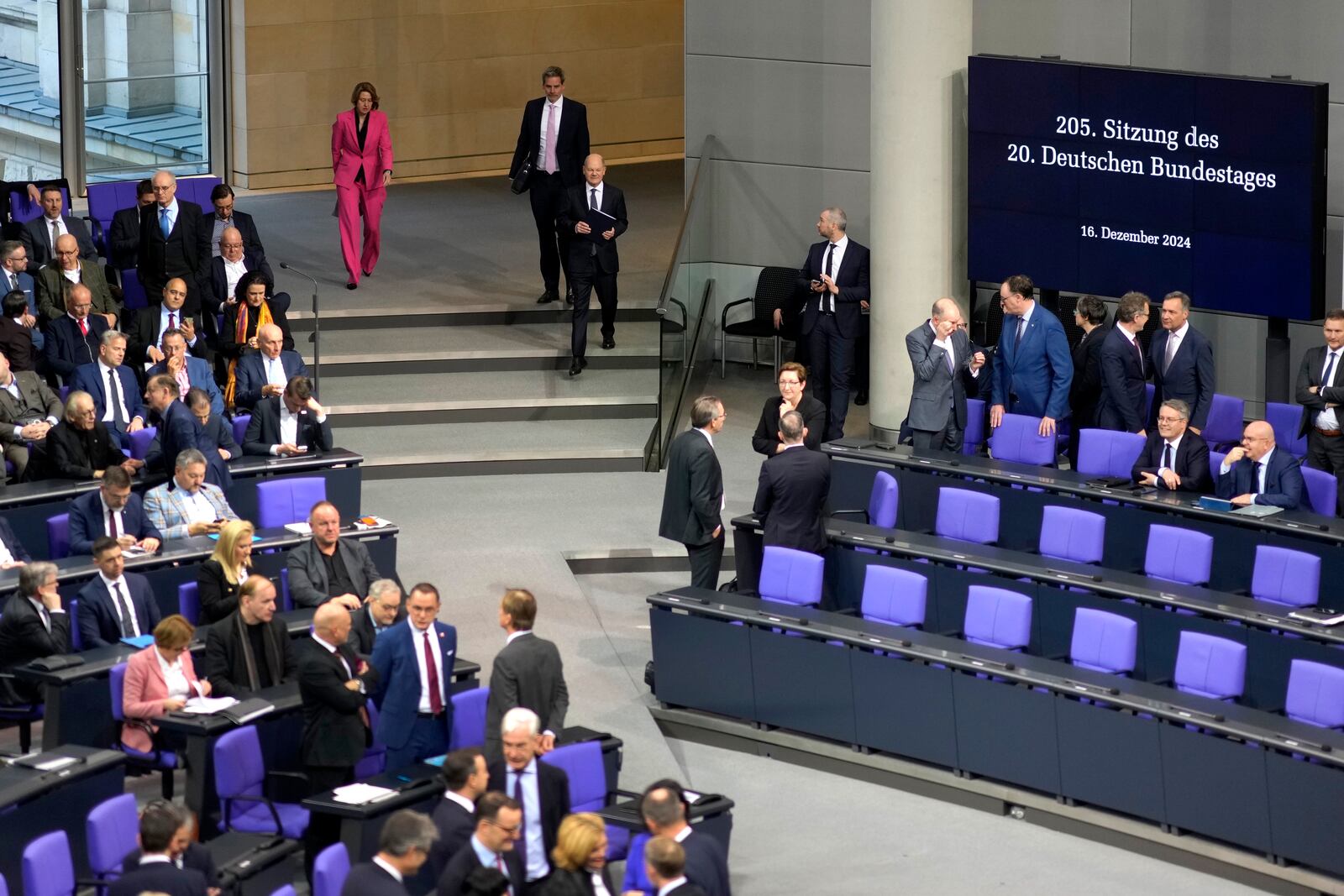 German Chancellor Olaf Scholz, centre arrives for a plenary session at the German parliament Bundestag where he faces a vote of confidence, Berlin, Germany, Monday, Dec. 16, 2024. (AP Photo/Markus Schreiber)