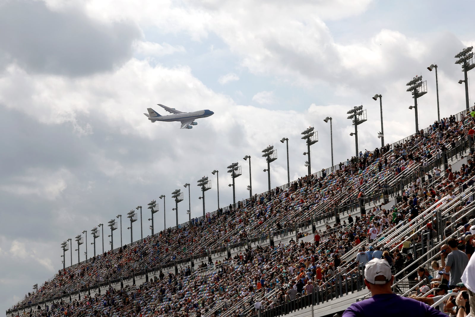 Air Force One with President Donald Trump on board flies overhead before arriving at the NASCAR Daytona 500 auto race at Daytona International Speedway, Sunday, Feb. 16, 2025, in Daytona Beach, Fla. (AP Photo/David Graham)