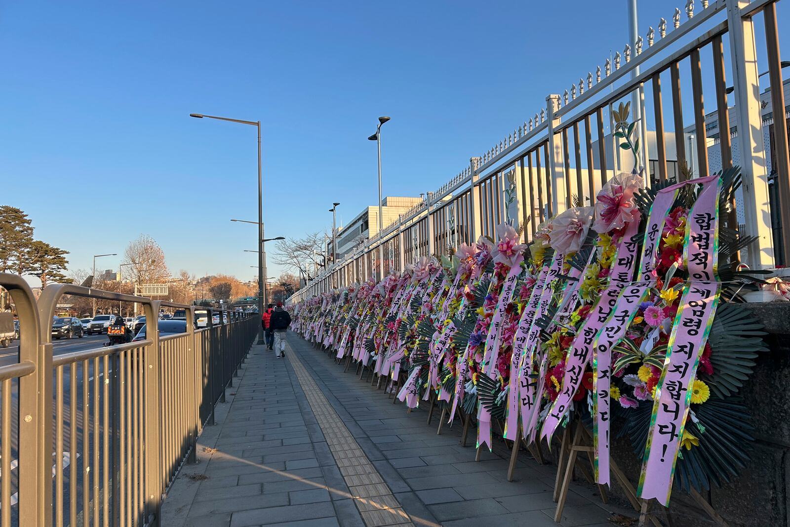 HOLD- Celebratory wreaths with messages supporting the detained President Yoon Suk Yeol line up along the street leading to his Hannam-dong residence on Thursday, Jan. 23, 2025, in Seoul. (AP Photo/Juwon Park)