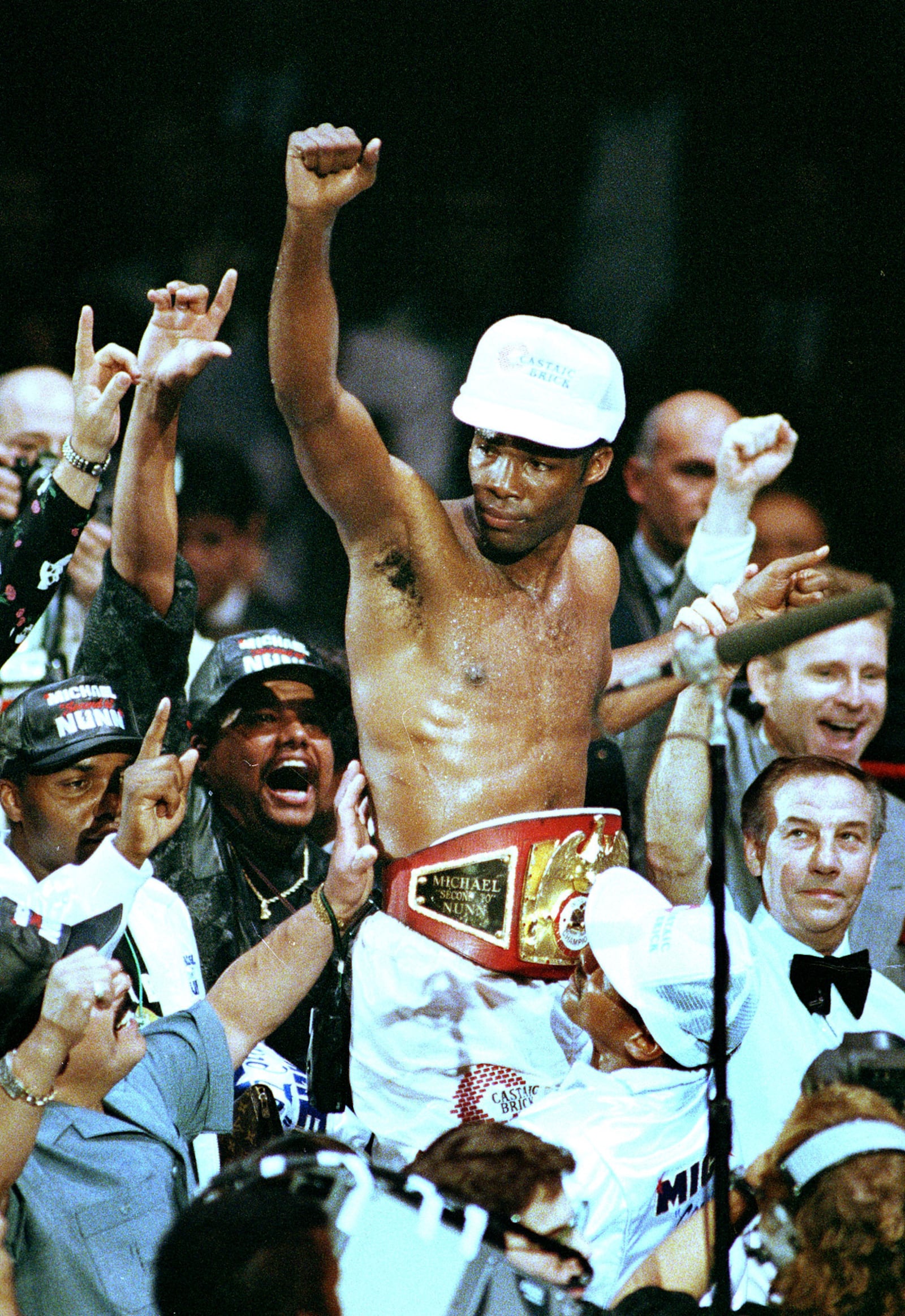 FILE - Boxer Michael Nunn is lifted in triumph after defeating Donald Curry in an International Federation middleweight title in Paris, Oct. 18, 1990. (AP Photo/Lionel Cironneau, File)