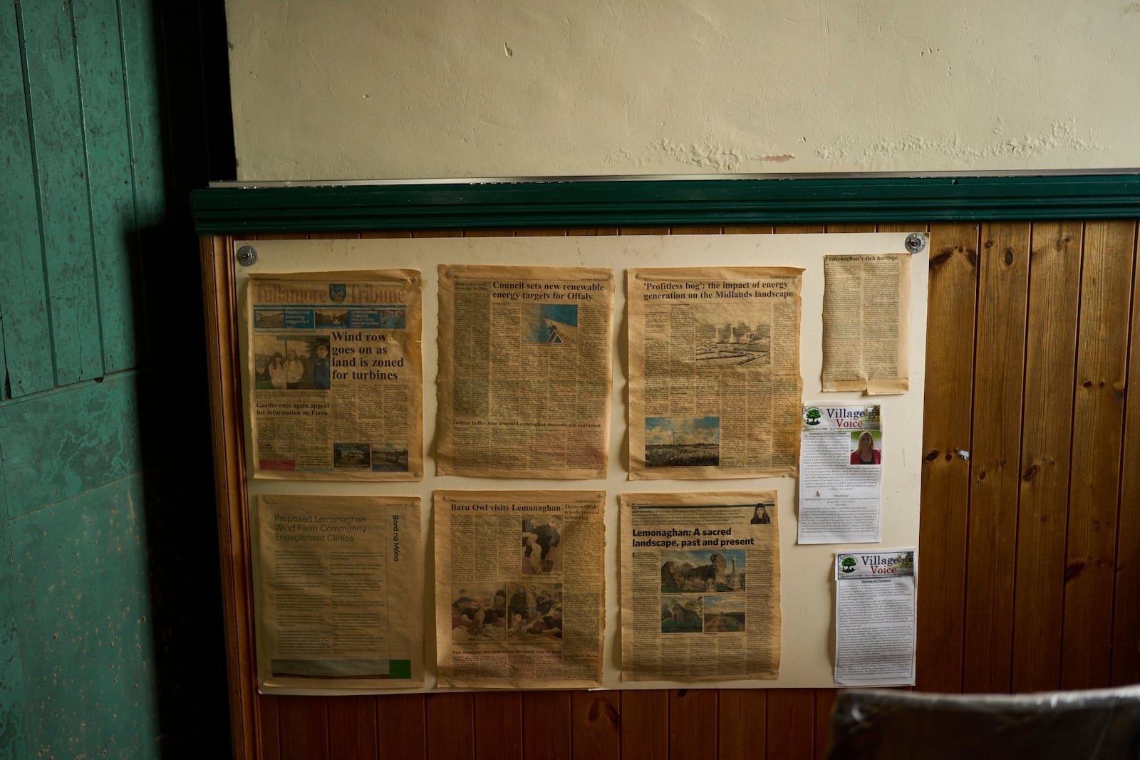 Old local newspapers are hanging on a wall inside an activist head quarters, in Lemanaghan, Ireland, Wednesday, Oct. 16, 2024, who oppose to the construction of wind farms. (AP Photo/Bram Janssen)