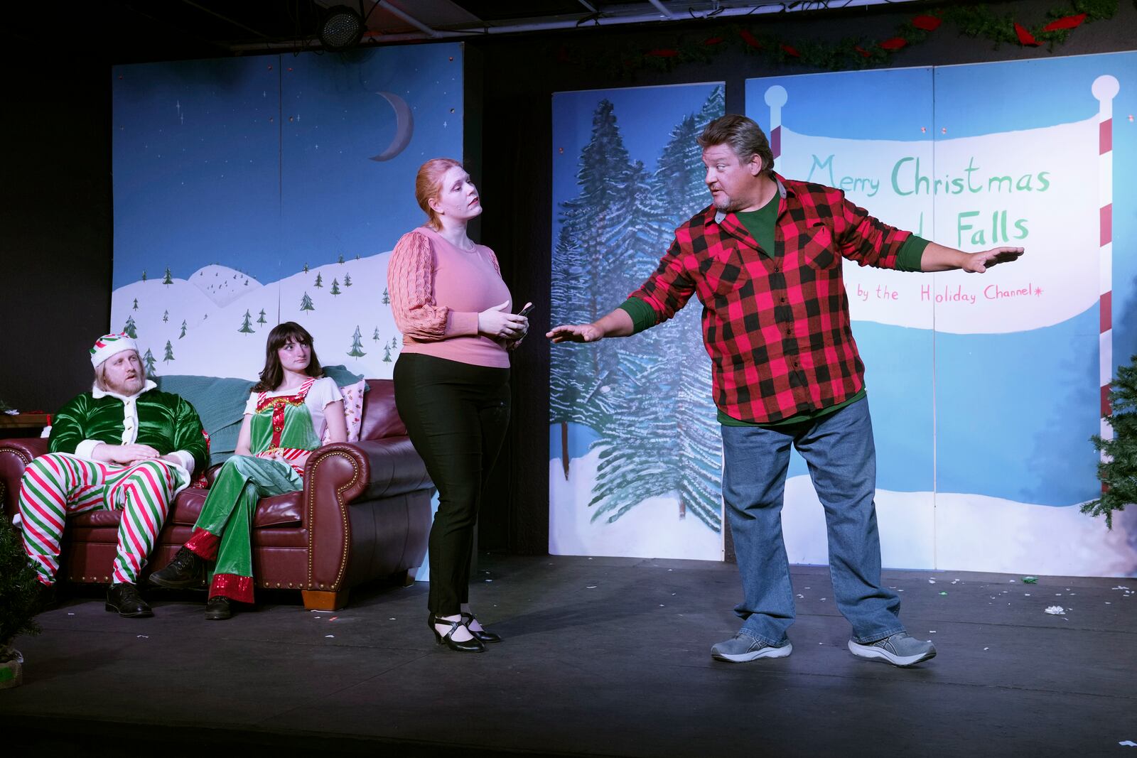 Howie Johnson, from right, appears with Rebecca Ulbrich, Kayla Patnod, and William Buckley during a dress rehearsal for the production of "The Holiday Channel Christmas Movie Wonderthon" at the Ghostlight Theatre in Sun City West, Ariz., on Dec. 9, 2024. (AP Photo/Ross D. Franklin)