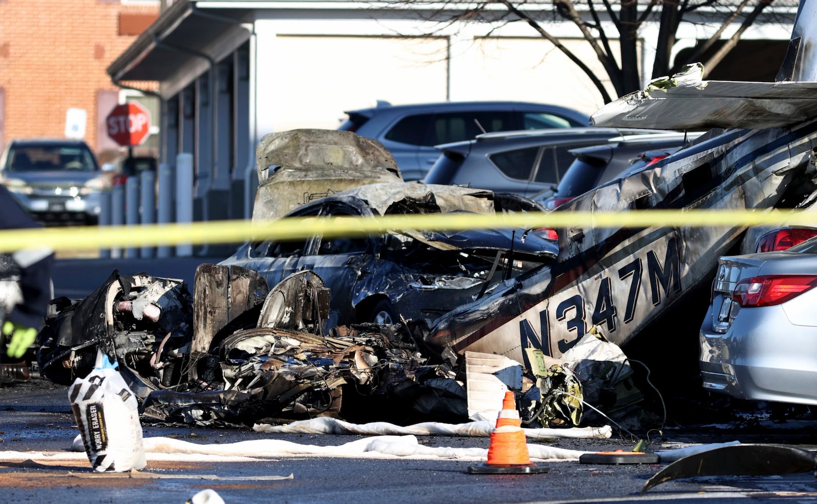 Debris is seen after a plane crashed in a parking lot of a retirement community Sunday, March 9, 2025, in Manheim Township, Pa. (Zach Gleiter/The Patriot-News via AP)