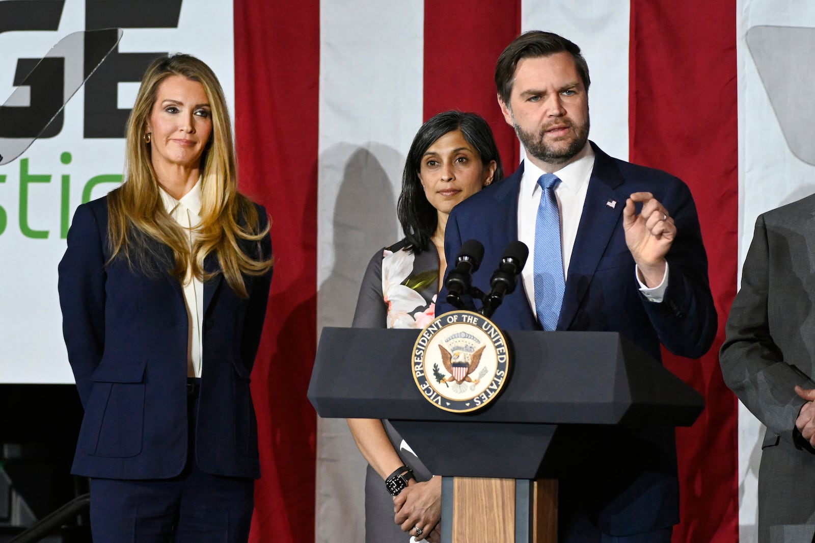 Vice President JD Vance, right, speaks at a rally about "America's industrial resurgence," as he is flanked by Administrator of the Small Business Administration Kelly Loeffler, far left, and his wife, Usha Vance, Friday, March 14, 2025, at Vantage Plastics in Bay City, Mich. (AP Photo/Jose Juarez)