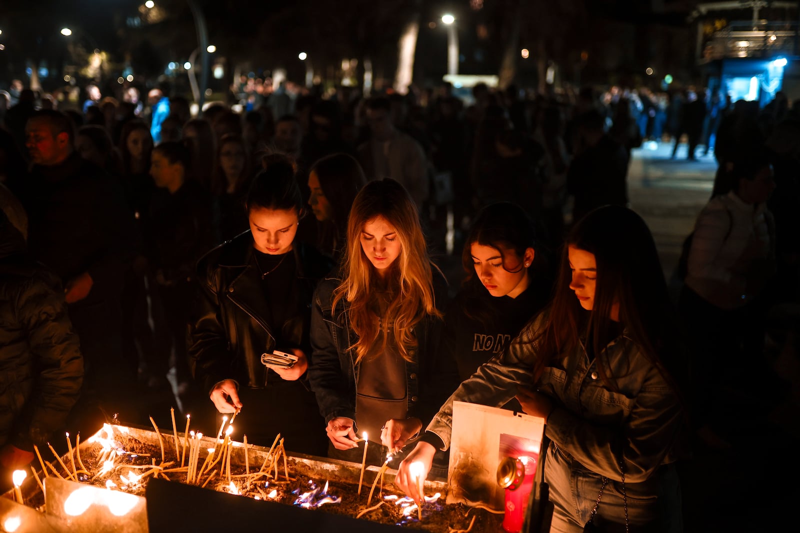 People wait in lines to light candles in the town of Kocani, North Macedonia, Sunday, March 16, 2025, following a massive fire in the nightclub early Sunday. (AP Photo/Armin Durgut)