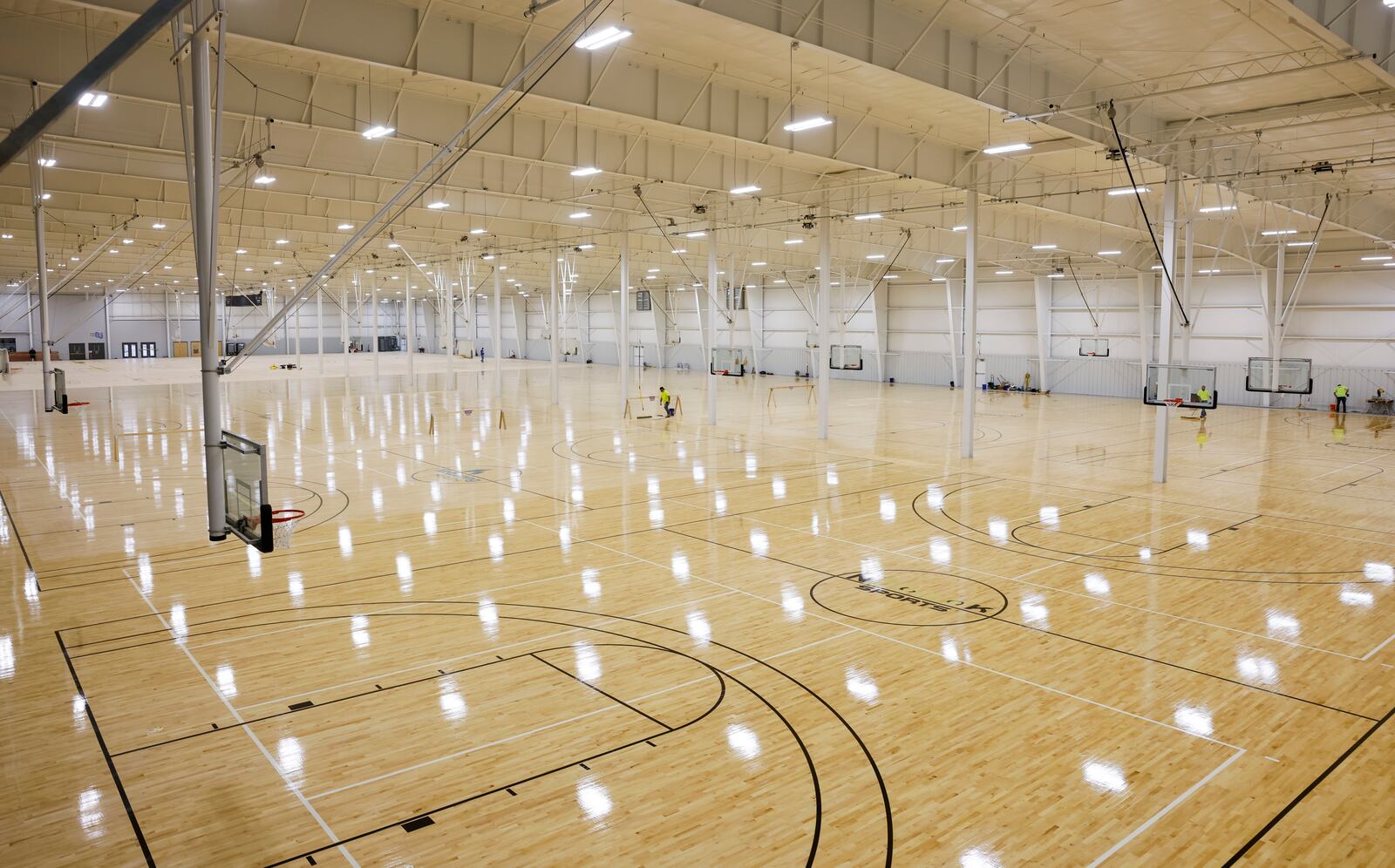 Crews are putting finishing touches on the hardwood and other courts at Spooky Nook sports Champion Mill. There are 14 hardwood basketball courts and 14 sports courts for a total of 28 basketball courts that can be converted to volleyball courts and other types of courts like pickleball, futsal or field hockey. Basketball and volleyball teams are already practicing at the facility. NICK GRAHAM/STAFF