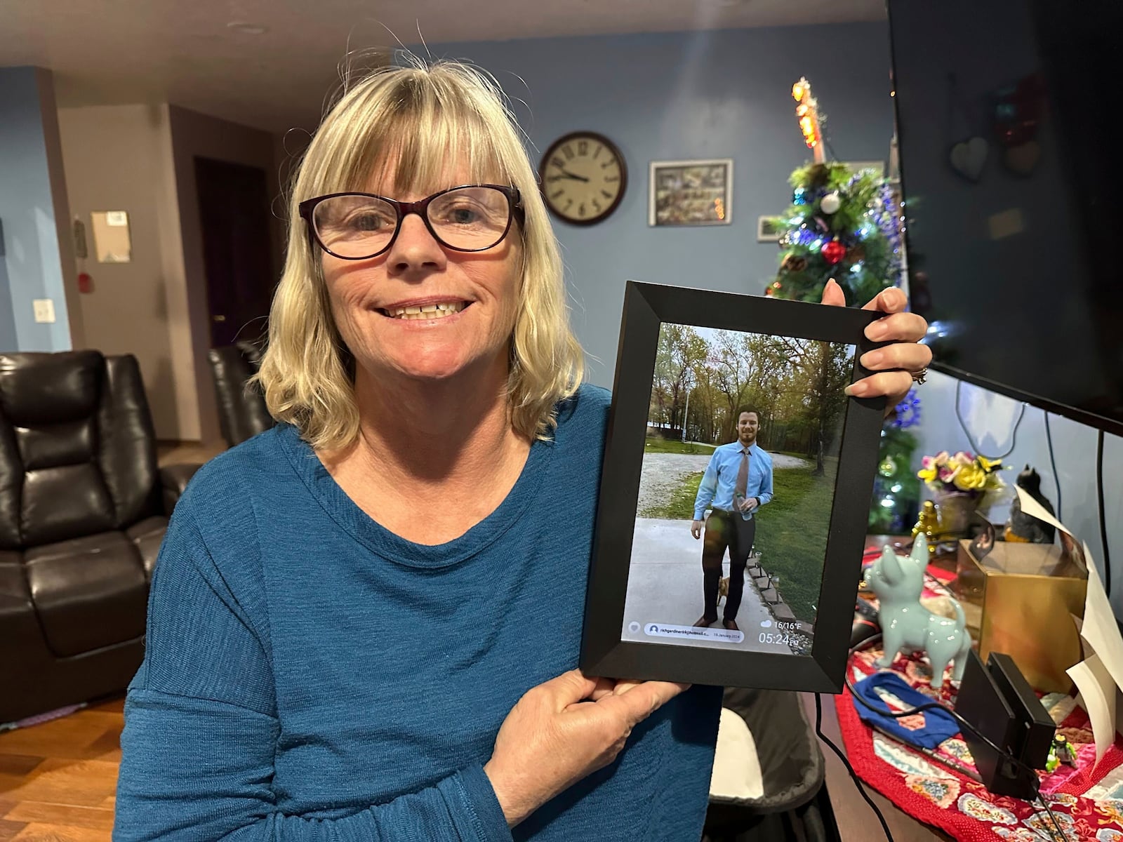 Stacey Collins Gardiner holds a picture of her son, Travis Timmerman, in her home in Urbana, Mo., Thursday, Dec. 12, 2024. Timmerman, an American citizen, was found outside Damascus, Syria, after having been imprisoned for months after crossing from Lebanon into Syria on a Christian pilgrimage. (AP Photo/Nick Ingram)