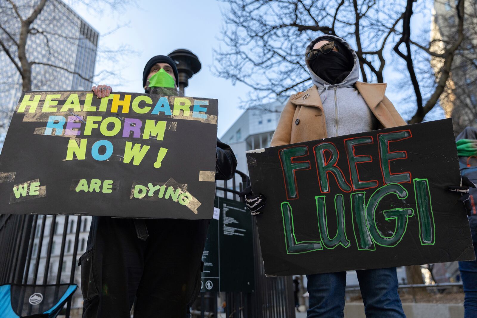 Luigi Mangione supporters hold signs outside the Supreme Court on Friday, Feb. 21, 2025 in New York. (AP Photo/Stefan Jeremiah)