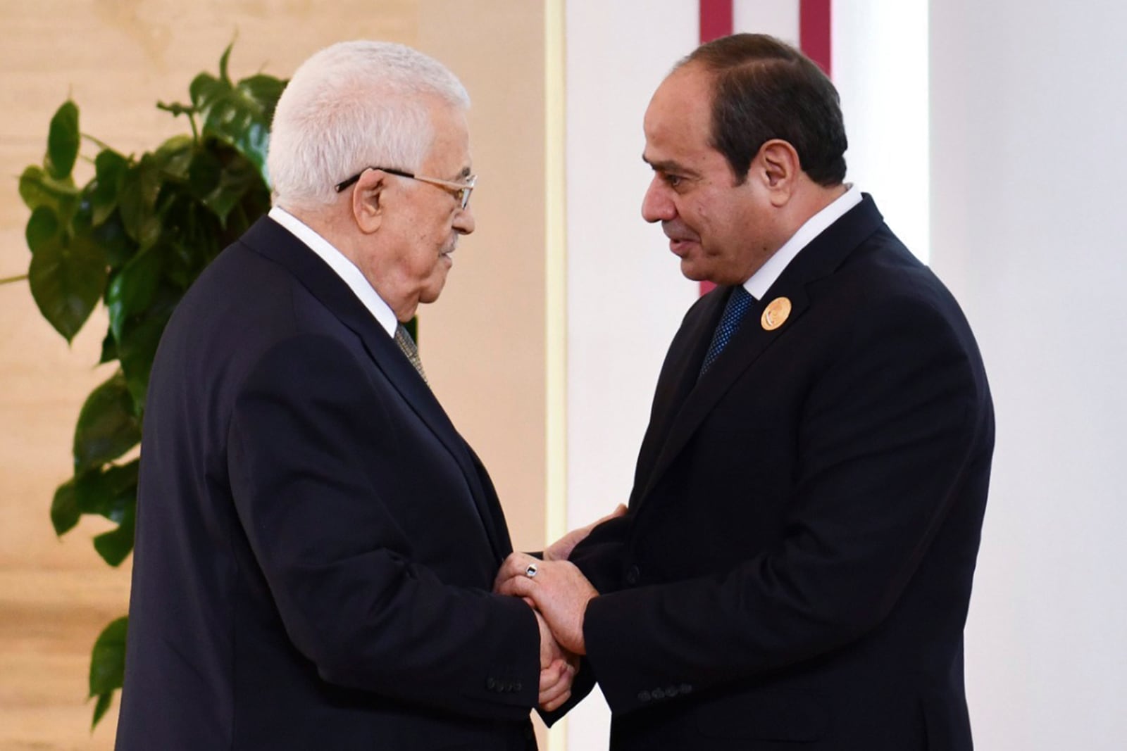 In this photo provided by Egypt's presidency media office, Egyptian President Abdel-Fattah el-Sissi, greets Palestinian Authority President Mahmoud Abbas, during the emergency Arab summit at Egypt's New Administrative Capital, just outside Cairo, Tuesday, March 4, 2025. (Egyptian Presidency Media Office via AP)