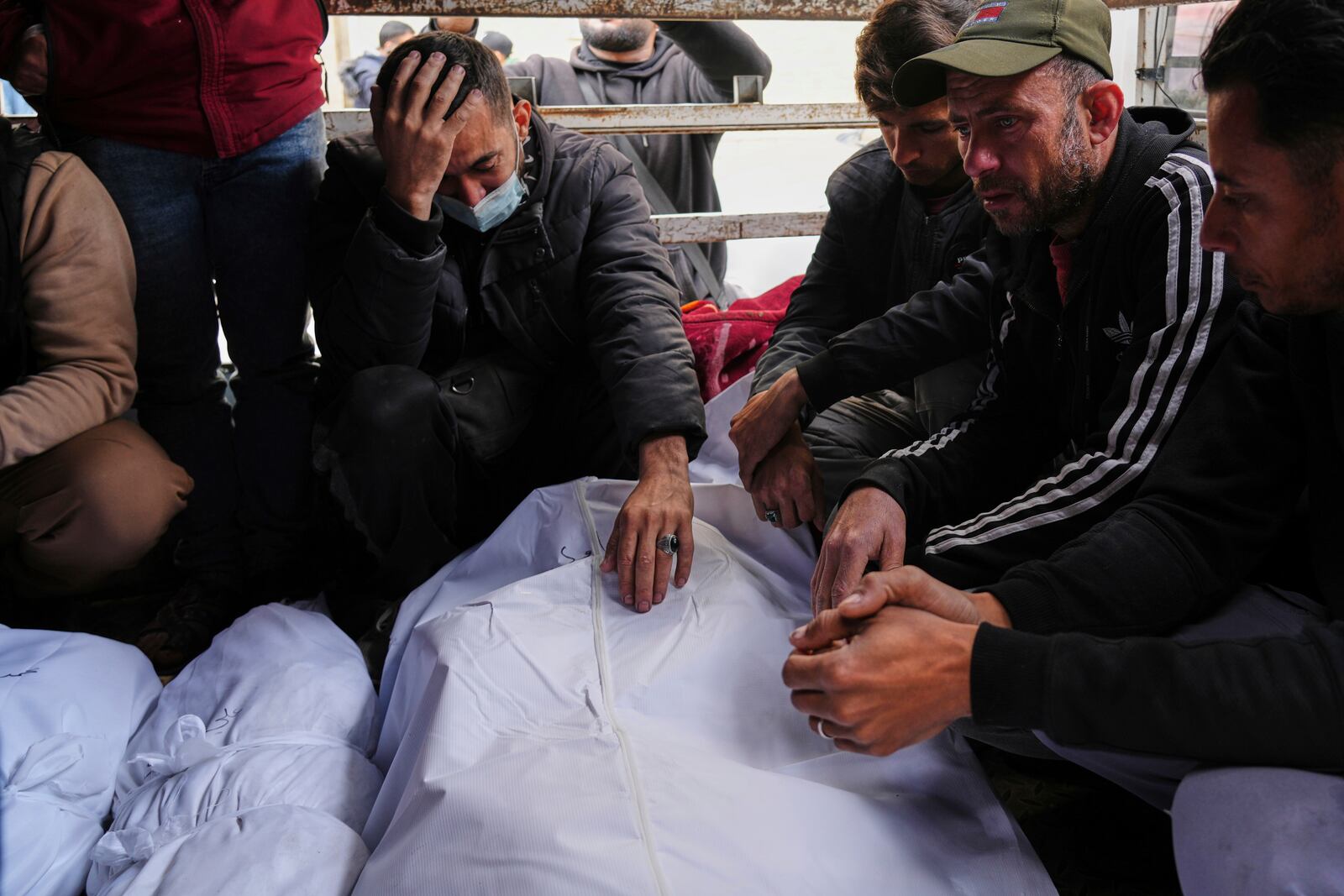 Mourners react over the bodies of Al-Mashharawi family members, who were killed in an Israeli airstrike that hit their home, at Al-Ahli Hospital in Gaza City on Saturday, March 22, 2025. (AP Photo/Jehad Alshrafi)