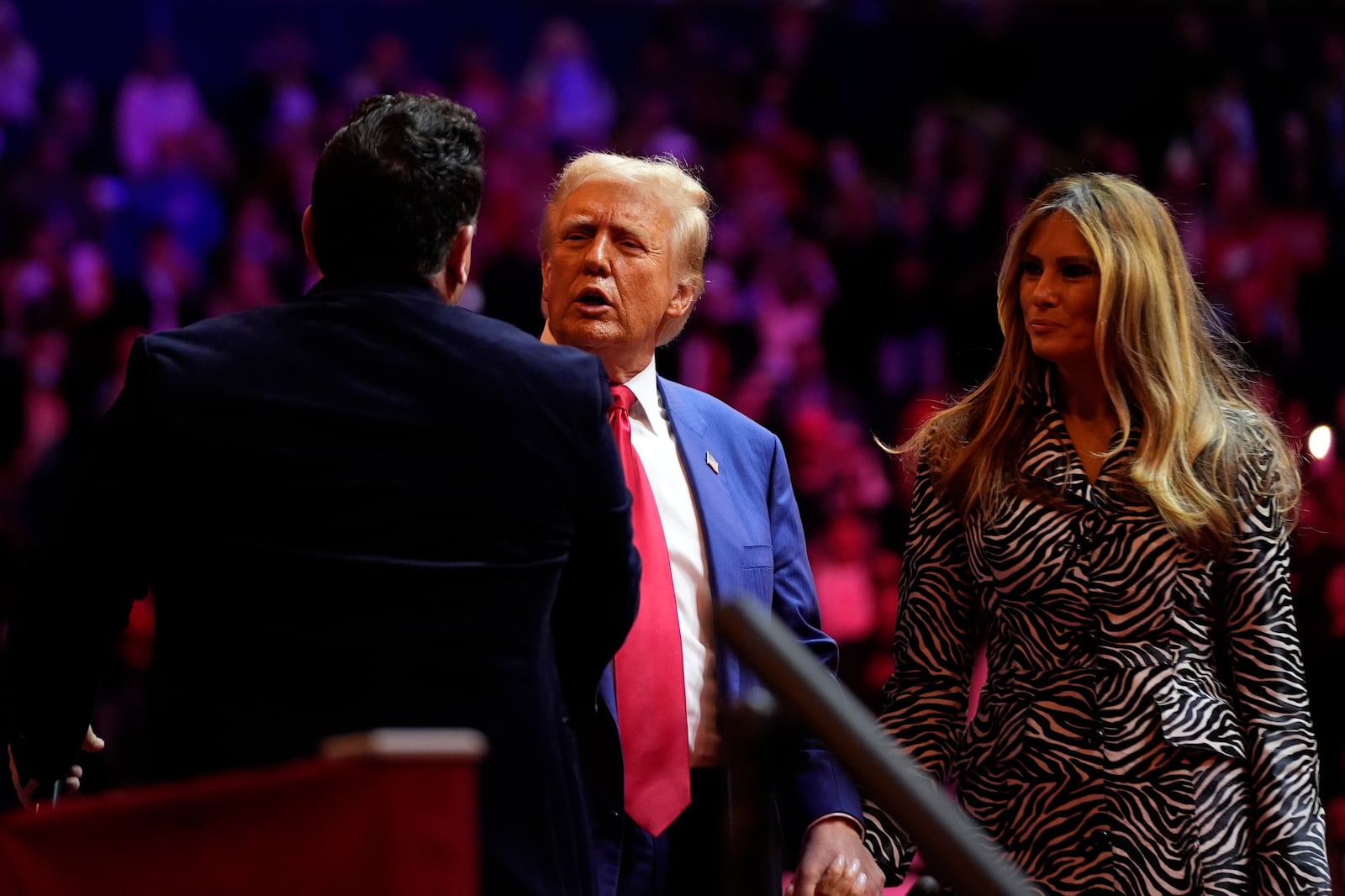 Republican presidential nominee former President Donald Trump and former first lady Melania Trump greet opera singer Christopher Macchio at a campaign rally at Madison Square Garden, Sunday, Oct. 27, 2024, in New York. (AP Photo/Alex Brandon)