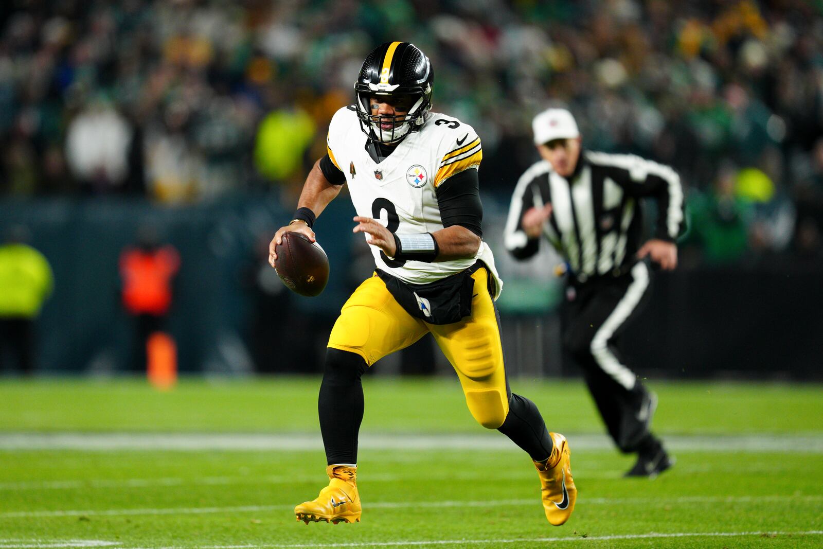 Pittsburgh Steelers quarterback Russell Wilson runs with the ball during the first half of an NFL football game against the Philadelphia Eagles on Sunday, Dec. 15, 2024, in Philadelphia. (AP Photo/Derik Hamilton)