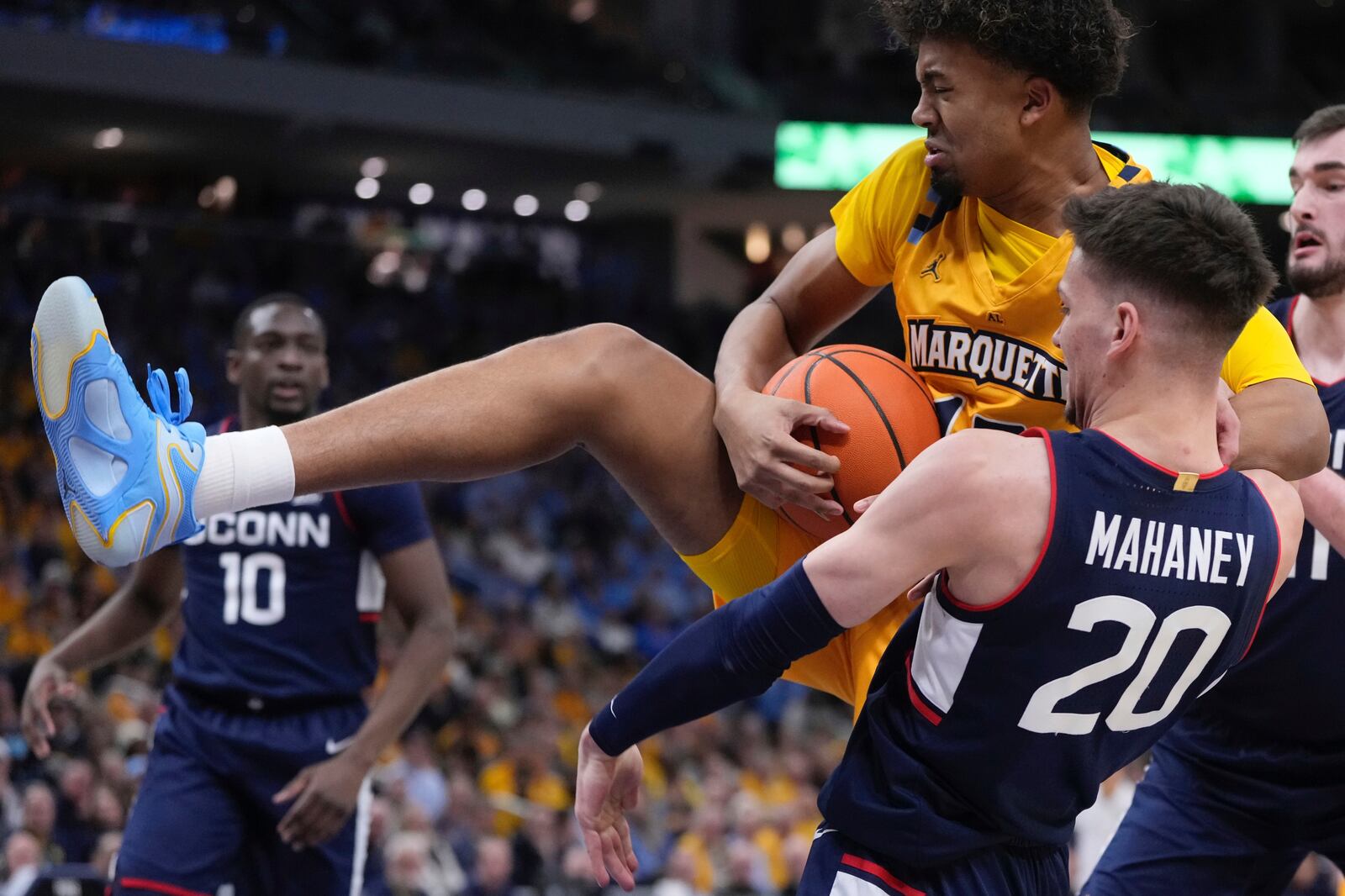 Marquette's Royce Parham grabs a rebound in front of UConn's Aidan Mahaney during the first half of an NCAA college basketball game Saturday, Feb. 1, 2025, in Milwaukee. (AP Photo/Morry Gash)