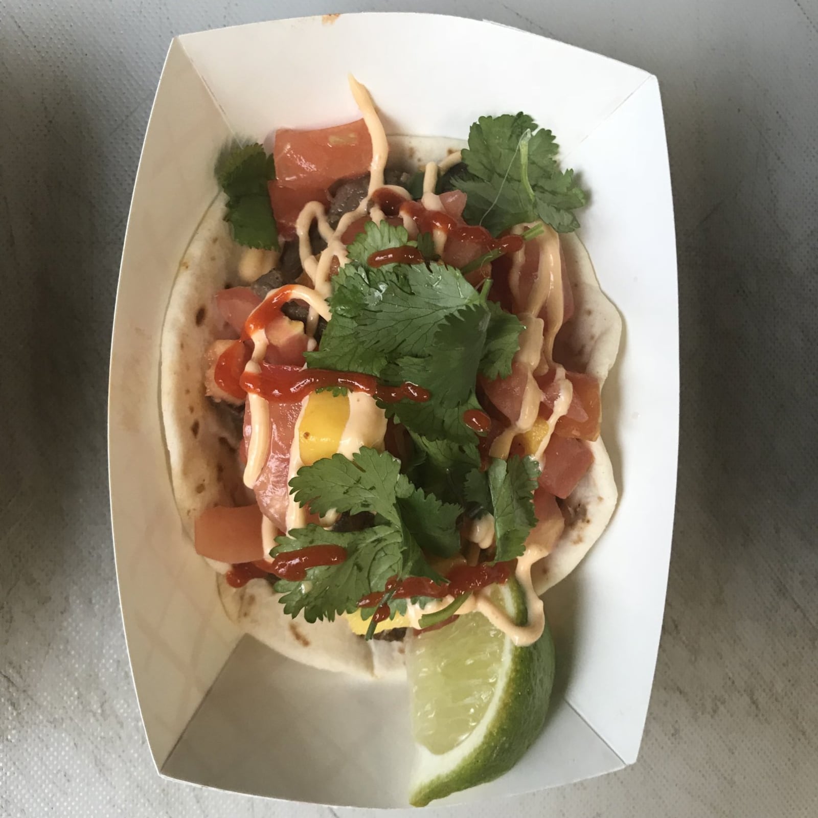 One of the three tacos to be served by the S.E.A. Cuisine Food Truck is this Cambodian shrimp taco, wrapped with mango pico de gallo, yum yum sauce, sriracha and cilantro. CONTRIBUTED