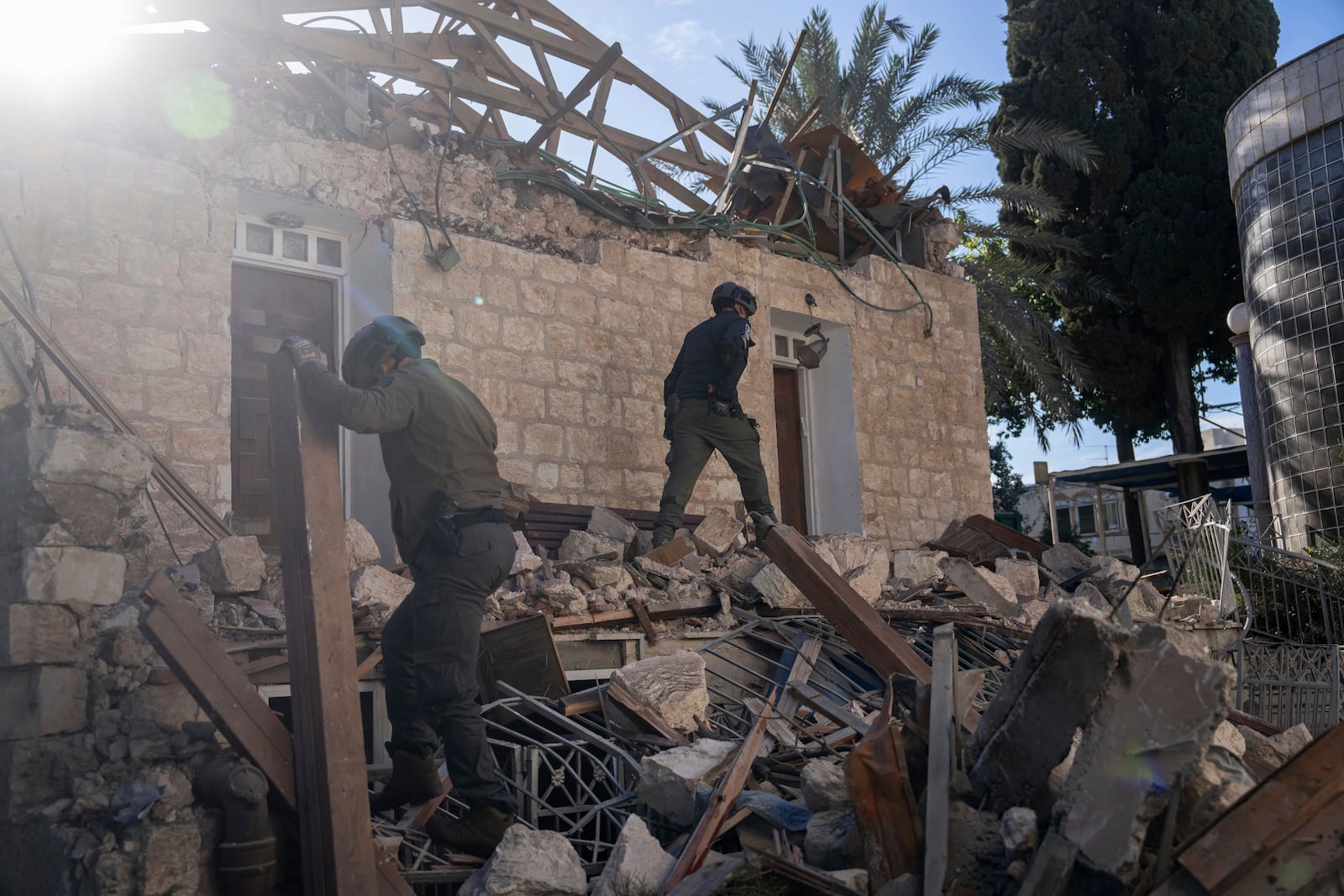 Israeli security forces check a house hit by a rocket fired from Lebanon on Saturday, in Haifa, Israel, Sunday, Nov. 17, 2024. (AP Photo/Ohad Zwigenberg)