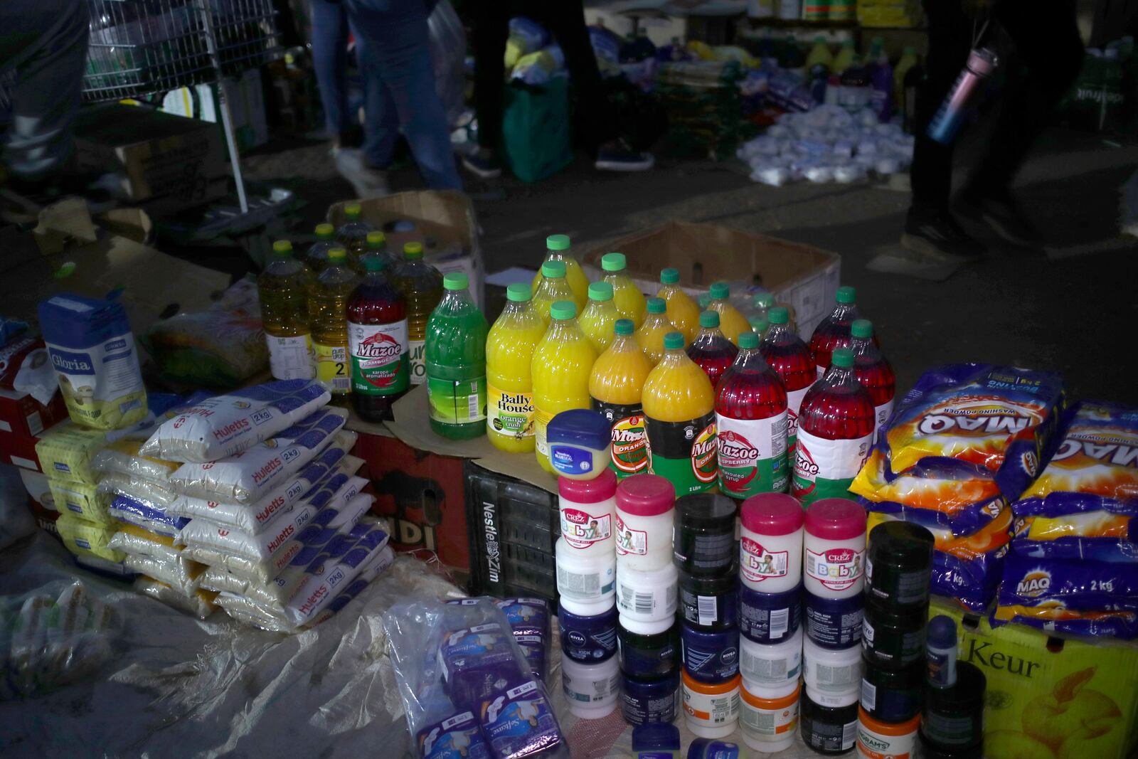 Basic commodities on display at an informal and illegal markets that pop up at night to avoid police raids in central Harare, Zimbabwe, Friday, Nov. 11, 2024. (AP Photo/Aaron Ufumeli)