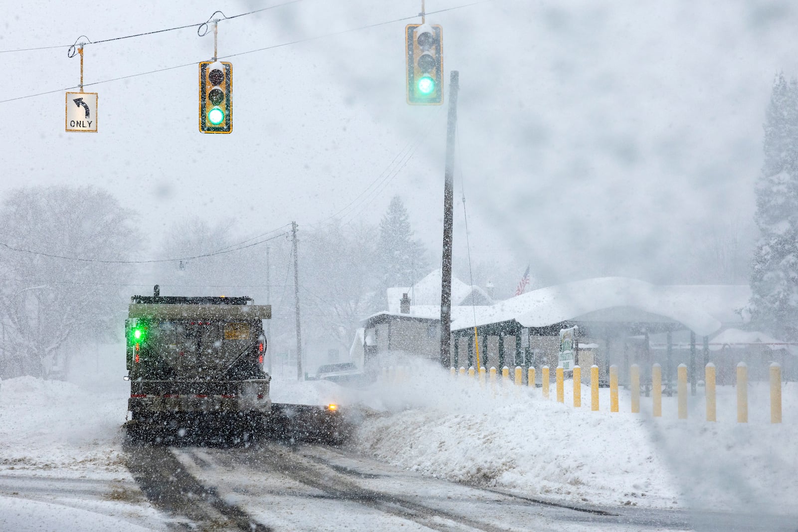 A plow removes snow from M-42 in Antrim County, Mich. on Sunday, Dec. 1, 2024. (Joel Bissell/Kalamazoo Gazette via AP)