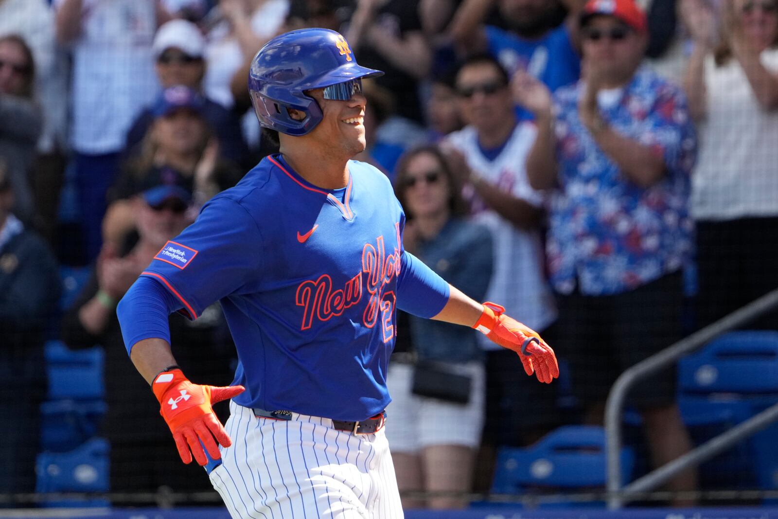 New York Mets' Juan Soto celebrates after hitting a solo home run during the first inning of a spring training baseball game against the Houston Astros Saturday, Feb. 22, 2025, in Port St. Lucie, Fla. (AP Photo/Jeff Roberson)