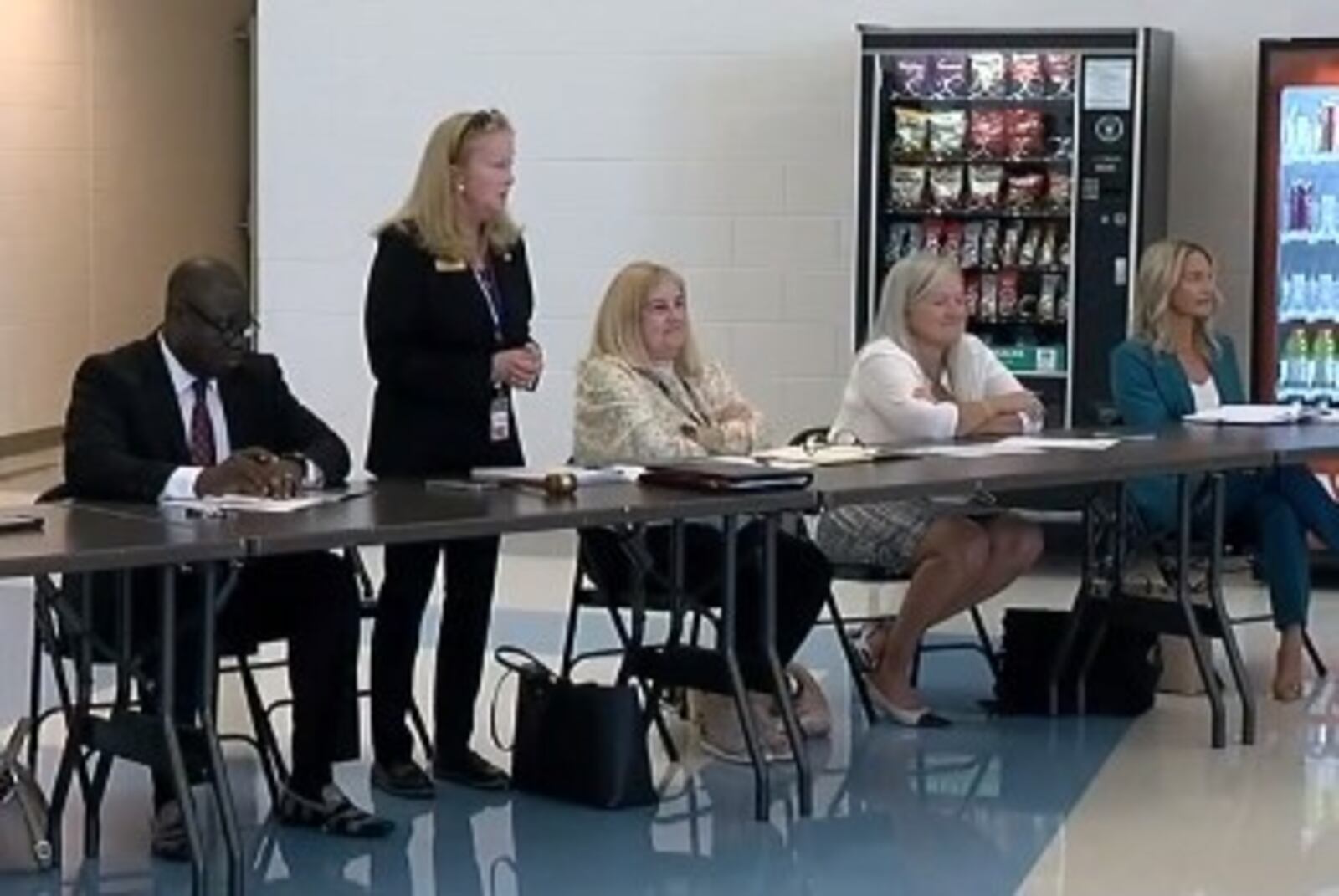 Lakota Local Schools Board Member Darbi Boddy attends the board meeting Oct. 2, 2023 after a judge said she could attend. This follows the filing of a civil protection order against her by fellow board member Isaac Adi. Boddy is seated at the far right, and Isaac Adi, in this photo, is at the left. There are two more members seated to Adi's side that are not pictured. WCPO/CONTRIBUTED