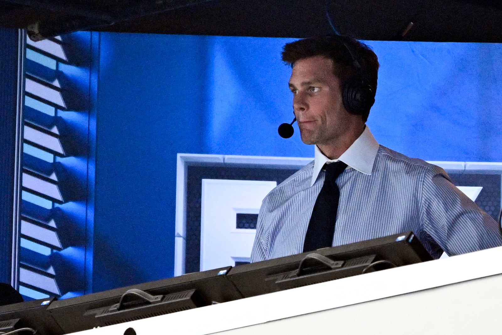 FILE 0- Former NFL quarterback Tom Brady looks on from the broadcast booth during the second half of an NFL football game between the Dallas Cowboys and the New Orleans Saints, Sunday, Sept. 15, 2024, in Arlington, Texas. (AP Photo/Jerome Miron, File)