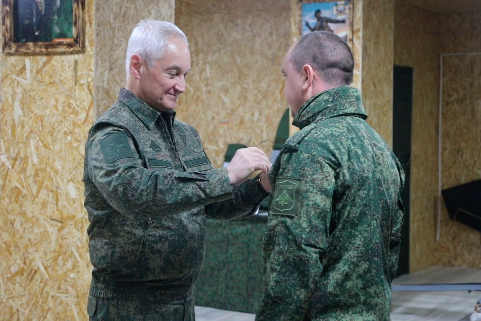 In this photo taken from a video released by Russian Defense Ministry press service on Friday, Nov. 22, 2024, Russian Defense Minister Andrei Belousov, left, gives an award to Russian serviceman of the Battlegroup North in an undisclosed location. (Russian Defense Ministry Press Service via AP)