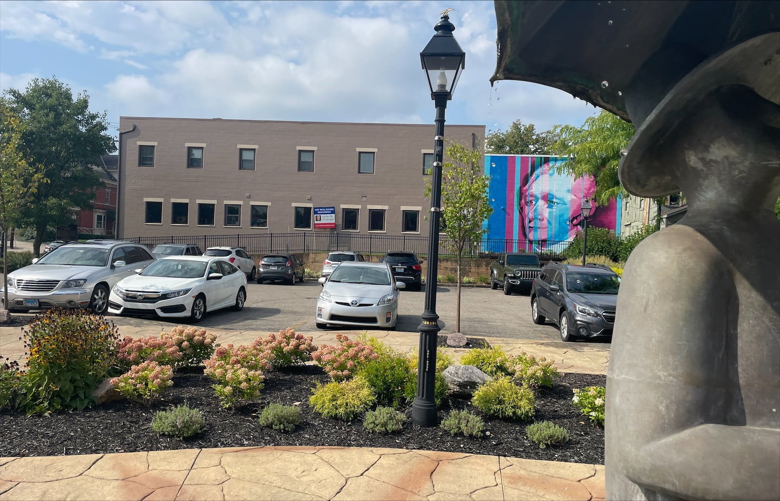 The city of Hamilton administration is discussing how to ensure its public parking lots are monitored to ensure turnover for visitors and residents using services along the main corridor through town. Pictured is the lot at Armstead Park on Main Street. MICHAEL D. PITMAN/STAFF