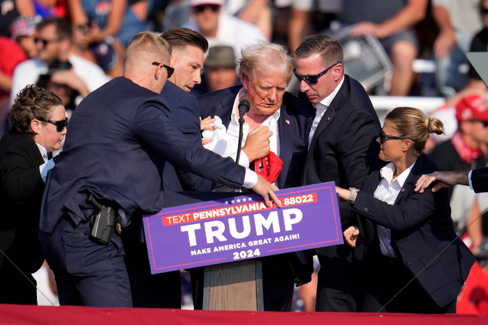 FILE - Republican presidential candidate former President Donald Trump is helped off the stage at a campaign event in Butler, Pa., July 13, 2024. (AP Photo/Gene J. Puskar, File)