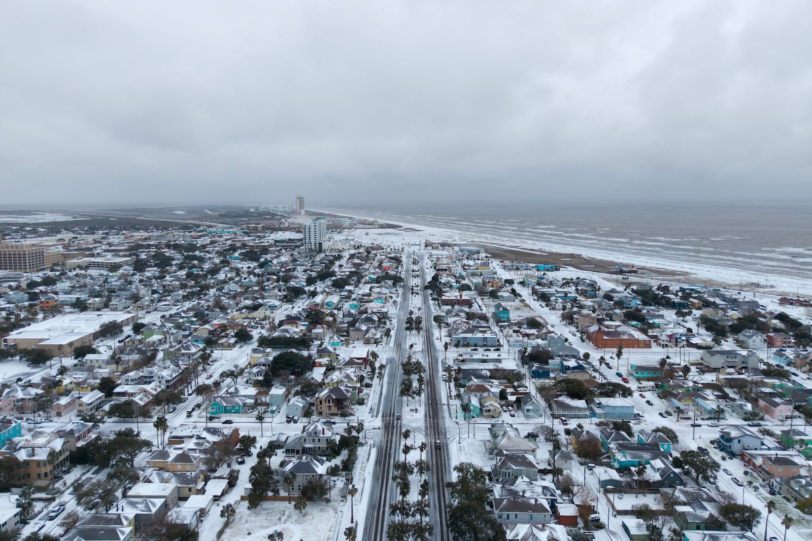 This photo provided by Michael Grimes of 409 Dronegraphy shows snow over Galveston Tx on the morning of Jan. 21, 2025. (Michael Grimes/409 Dronegraphy via AP)