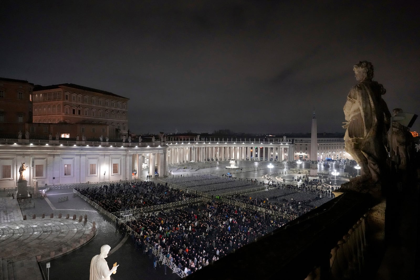 People attend a rosary prayer service held for the health of Pope Francis in St Peter's Square at The Vatican, Monday, Feb. 24, 2025. (AP Photo/Kirsty Wigglesworth)