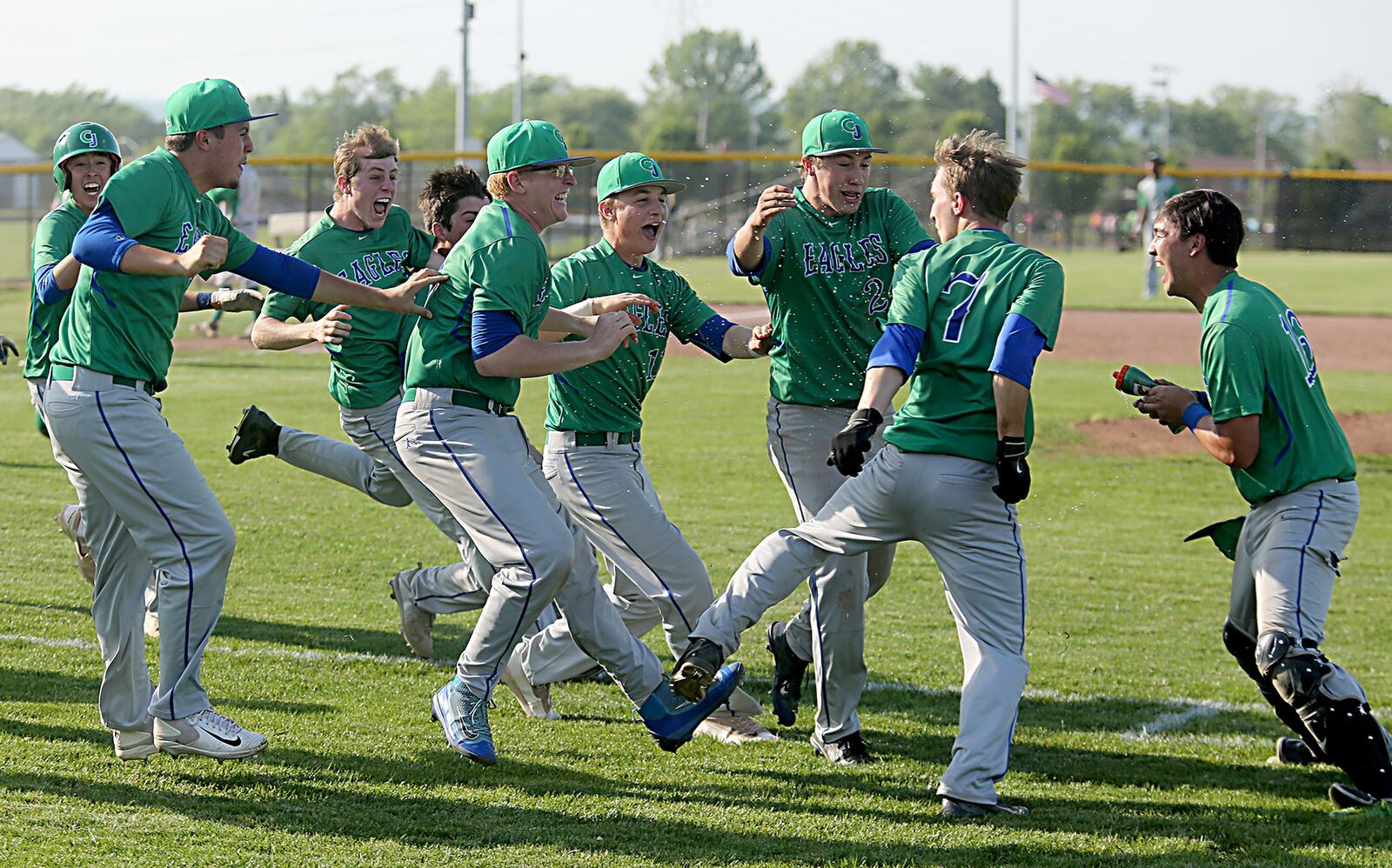 Chaminade Julienne players celebrate after Mark Barhorst (7) knocked in the winning run against Badin during their Division II sectional final at Miamisburg on Thursday. CONTRIBUTED PHOTO BY E.L. HUBBARD