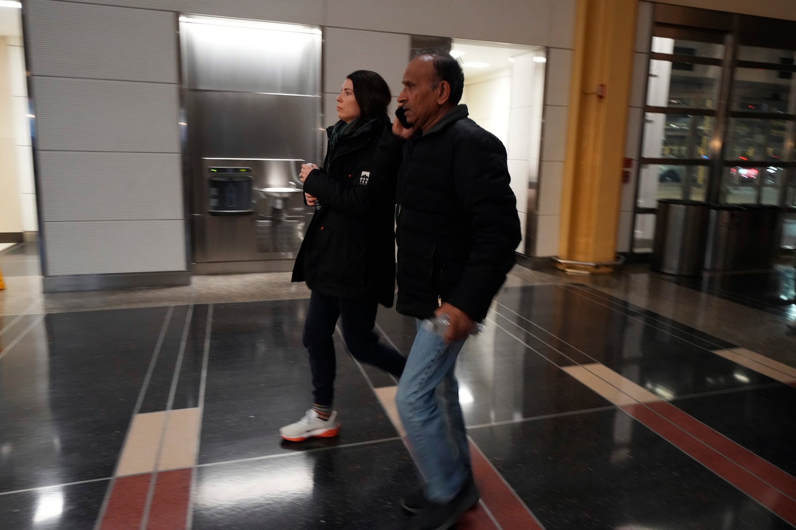 People arrive to check on passengers at Ronald Reagan Washington National Airport, Thursday, Jan. 30, 2025, in Arlington, Va. (AP Photo/Julio Cortez)