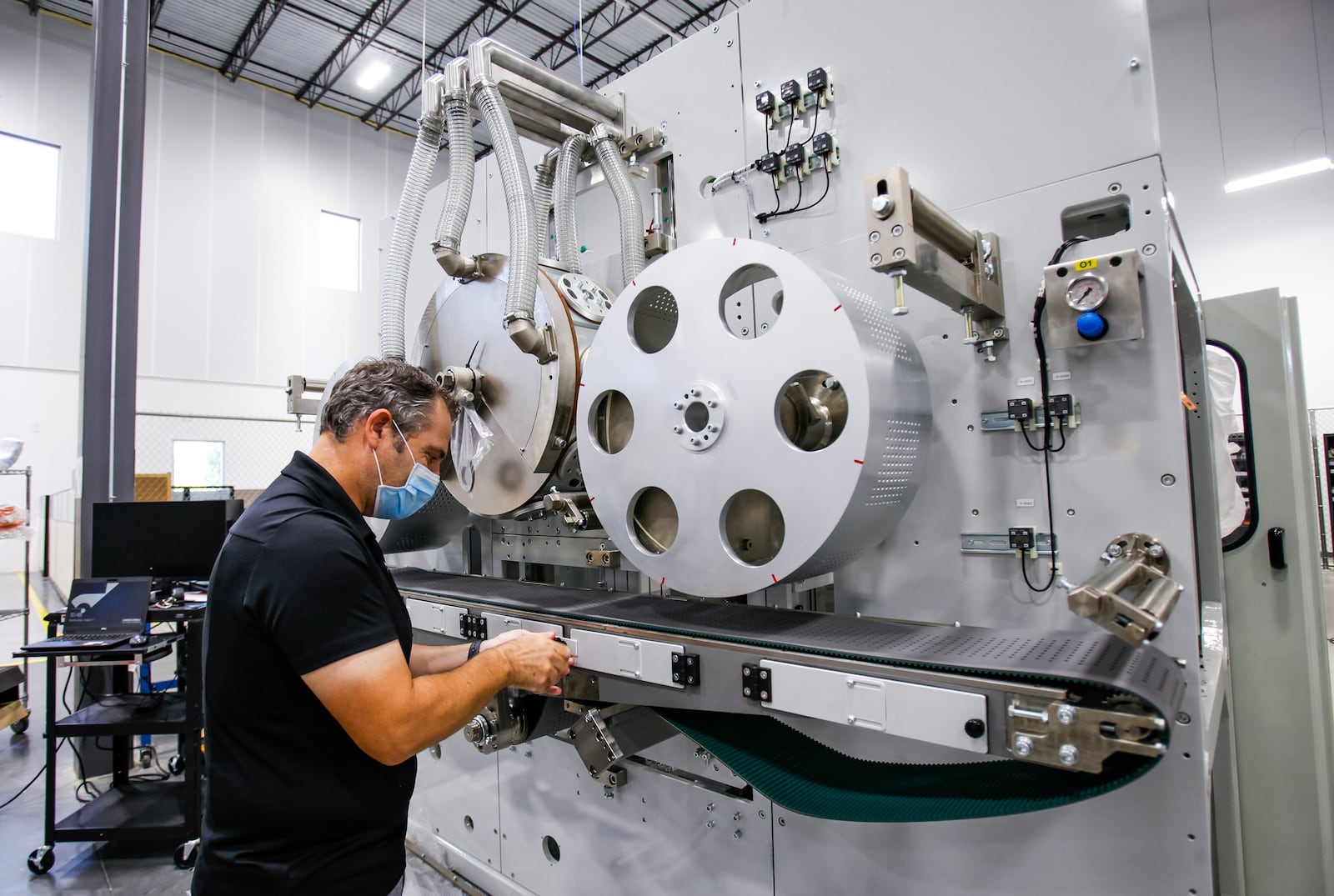 Engineering and sourcing manager Cristian Giuliani looks at a machine at Fameccanica North America, Inc. that has moved into the one of the new buildings in the Trade Center development off of Union Centre Boulevard in West Chester Township. Fameccanica engineers and produces machinery to make products such as diapers, feminine hygiene products, toilet paper and paper towels and more. NICK GRAHAM / STAFF