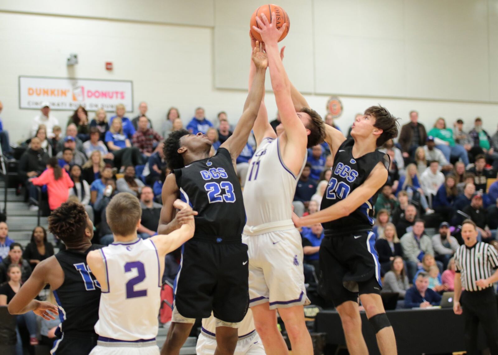 Cincinnati Christian’s Cameron Rogers (23) and Bryson Teague (20) battle Miami Valley Christian Academy’s Joe Lusby (11) for a rebound during Saturday night’s Division IV district semifinal basketball game at Taylor. CCS won 55-40. PHOTO BY KRAE/WWW.KRAEPHOTOGRAPHY.COM