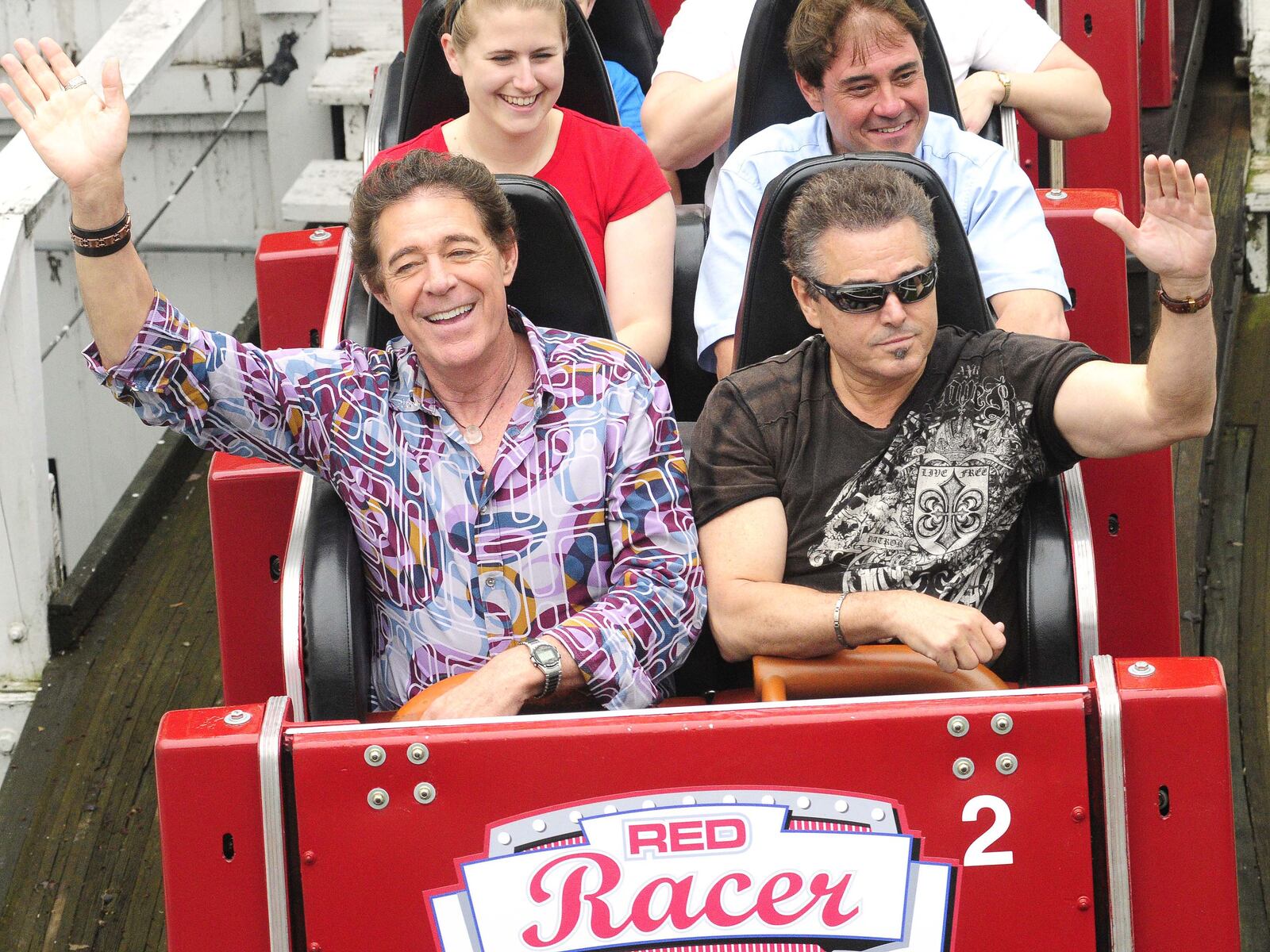 Cast members of the 70's TV Show "The Brady Bunch" reunited at Kings Island Sunday, May 19, 2013. Barry Williams (Greg Brady) and Christopher Knight (Peter Brady) share the front row of the Racer roller coaster for their second ride of the day. The reunion with Barry, Christopher and Susan Olsen (not pictured) marked forty years since the Kings Island Brady Bunch episode aired. The three spent the morning talking with media and radio winners before heading to do three shows for guest of the park. (CONTRIBUTED BY MARTIN WHEELER)