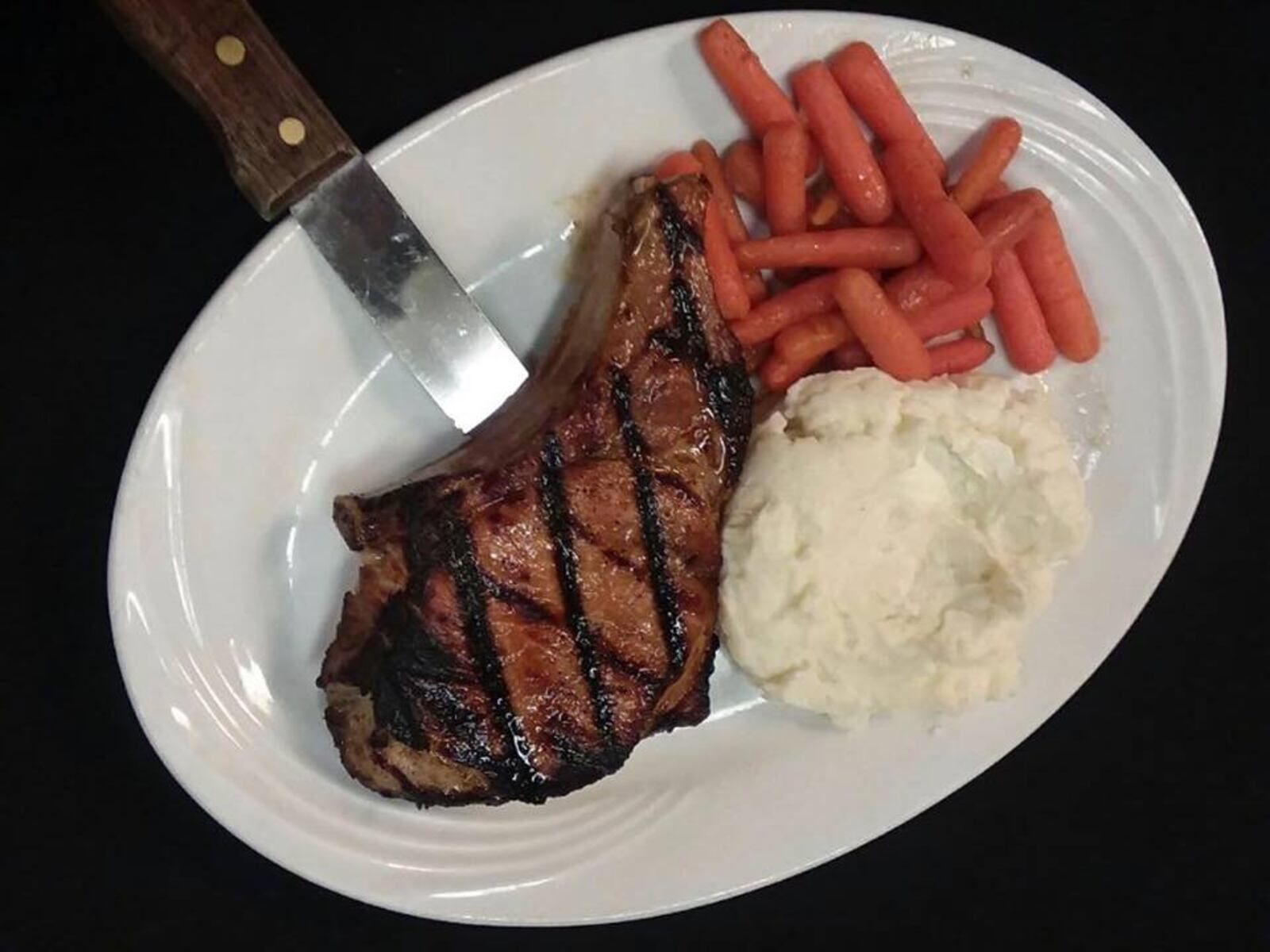 The Beer-Brined Pork Chop at Eli’s Southern Comfort Food. Photo by Jeff Zaret